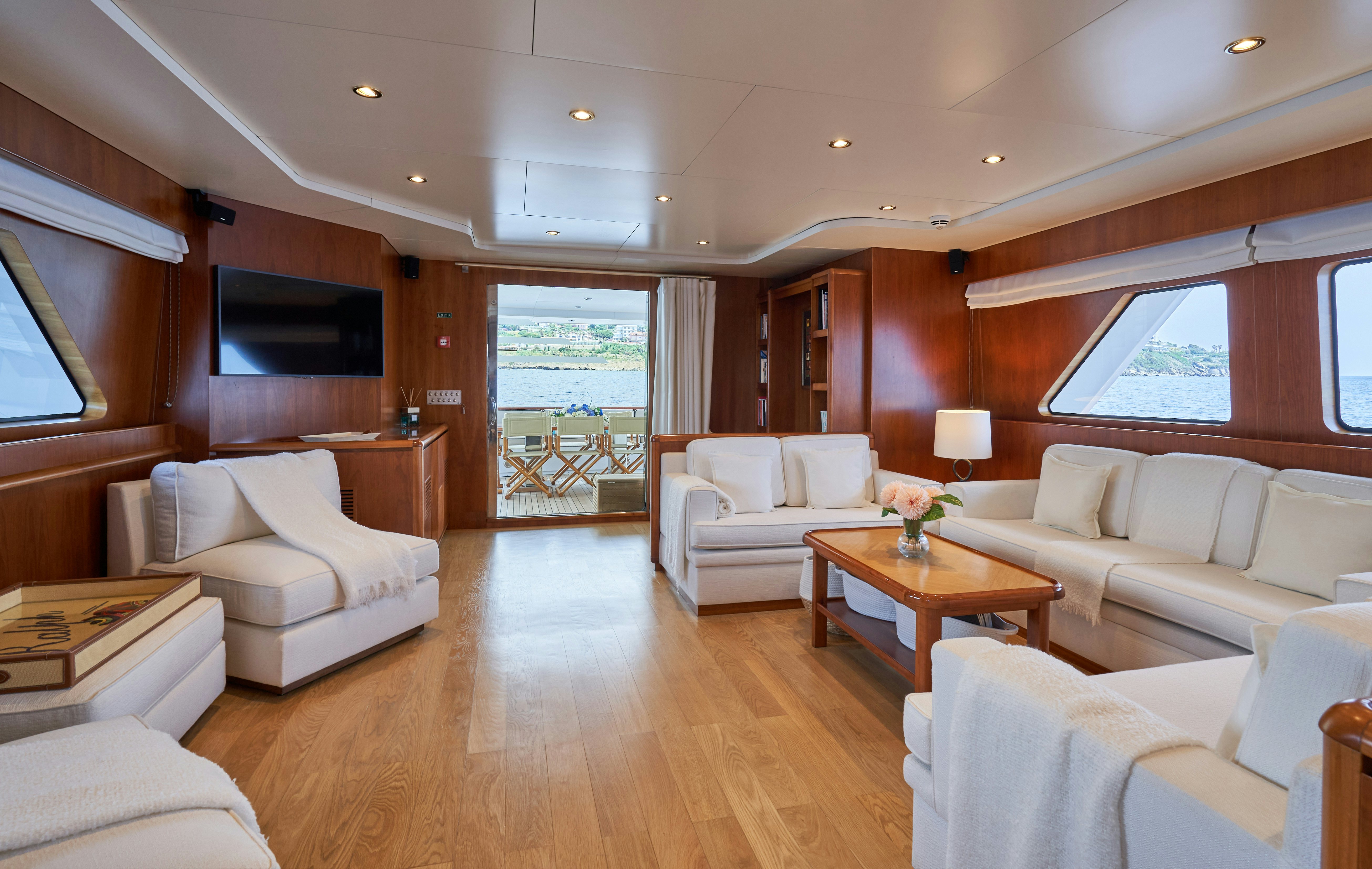 a living room with a wood floor aboard L'INSTANT IV Yacht for Sale