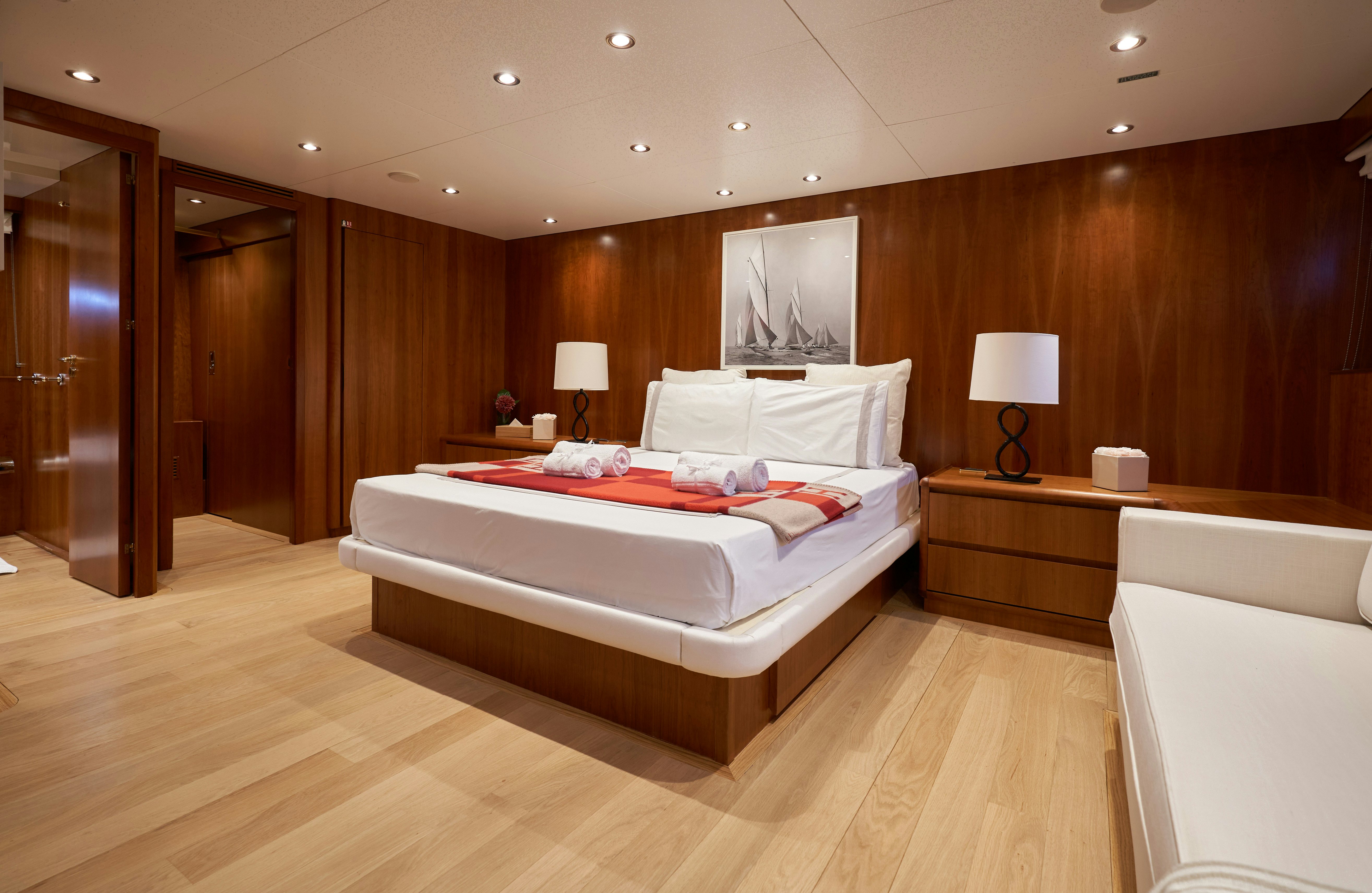 a large bedroom with a large bed aboard L'INSTANT IV Yacht for Sale