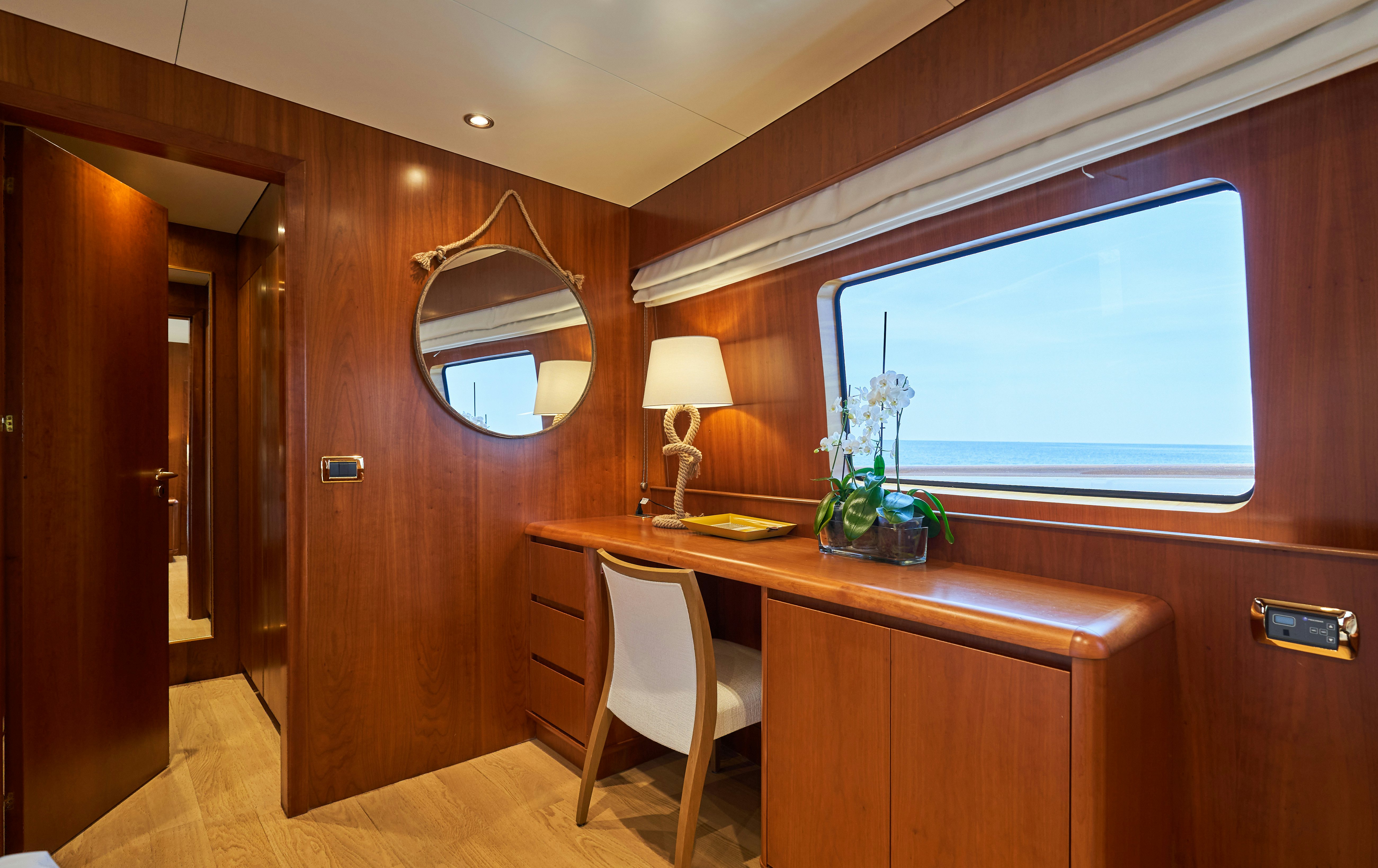 a room with a desk and a window aboard L'INSTANT IV Yacht for Sale