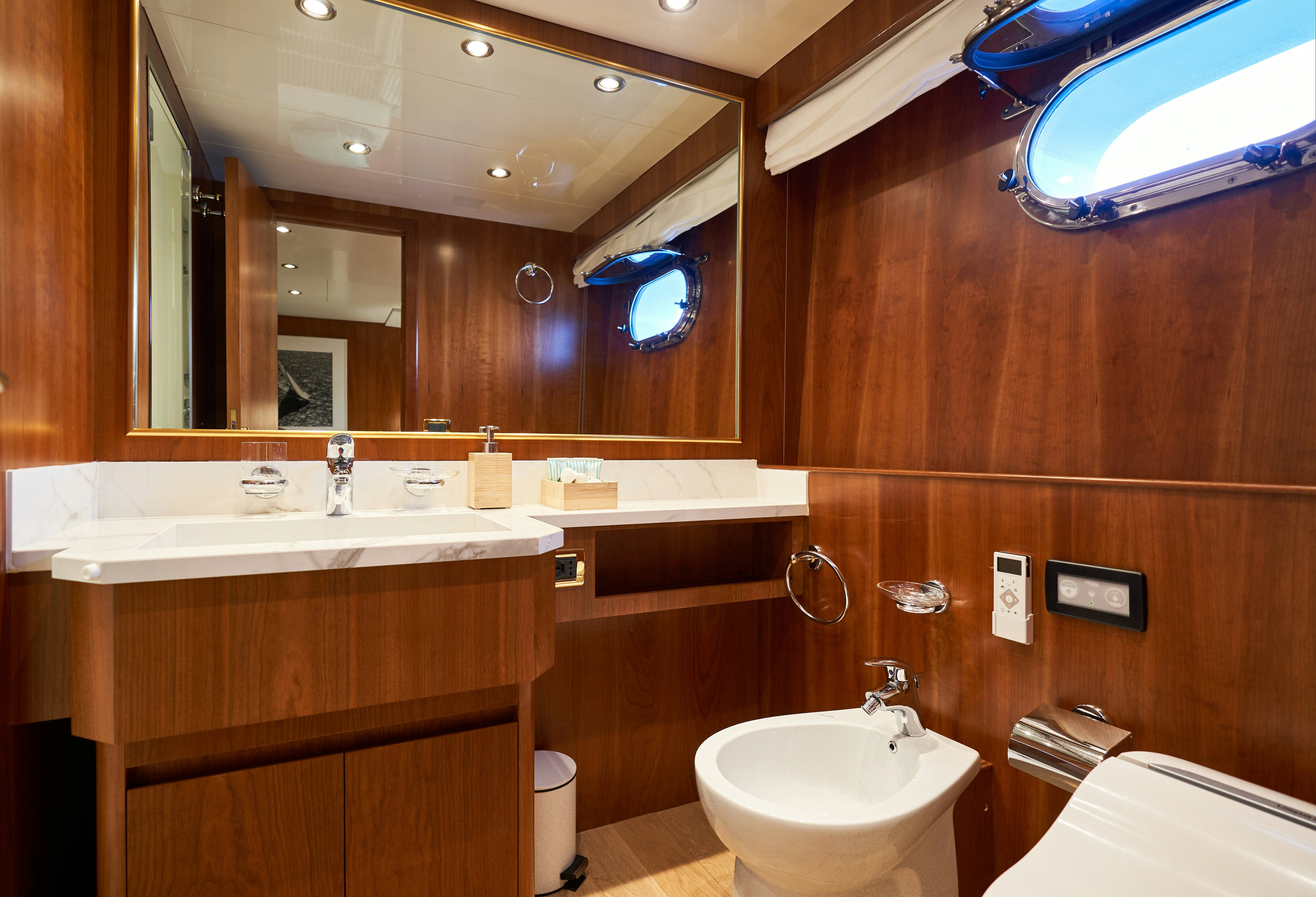 a bathroom with a large mirror aboard L'INSTANT IV Yacht for Sale