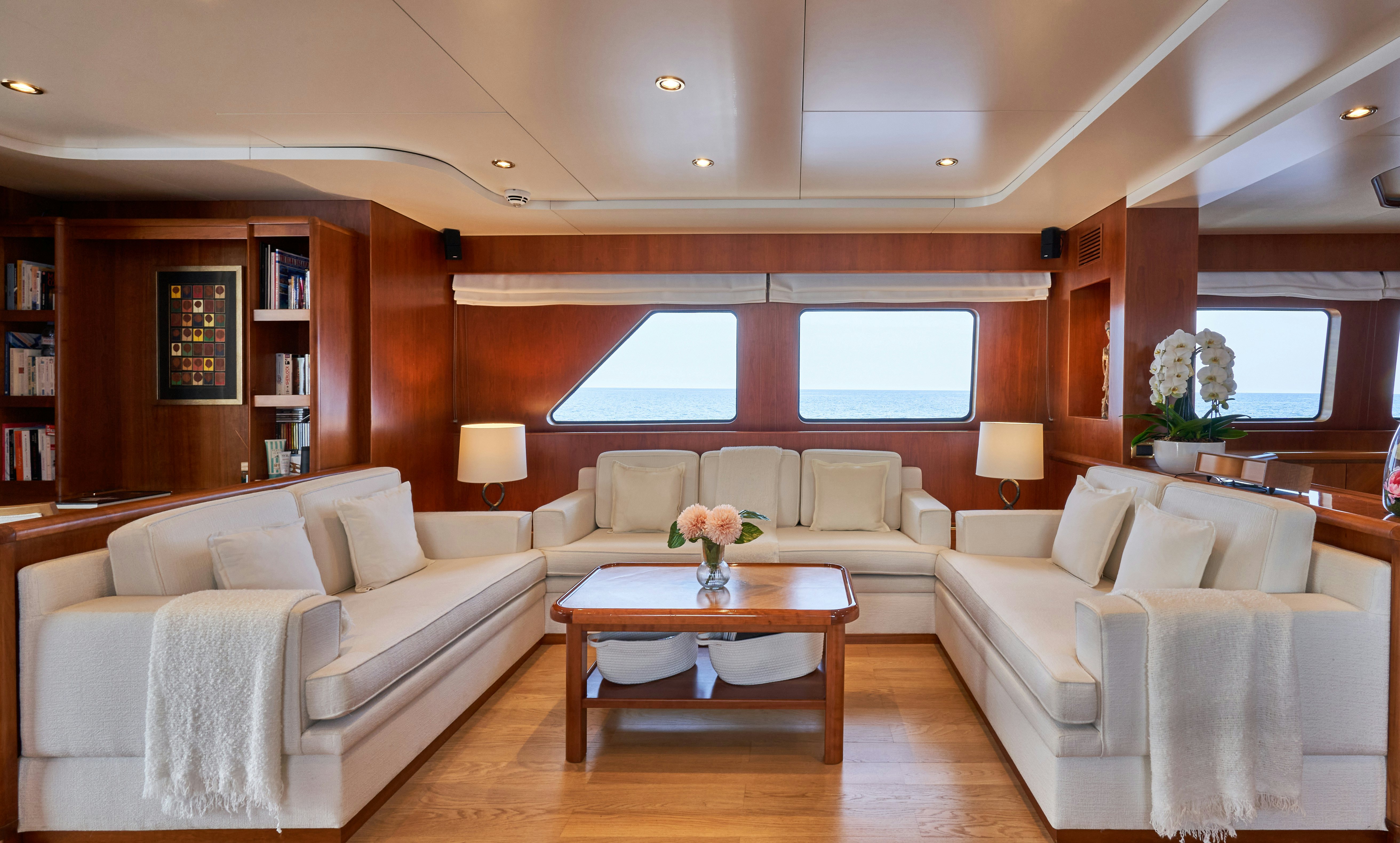 a living room with a couch and a coffee table aboard L'INSTANT IV Yacht for Sale
