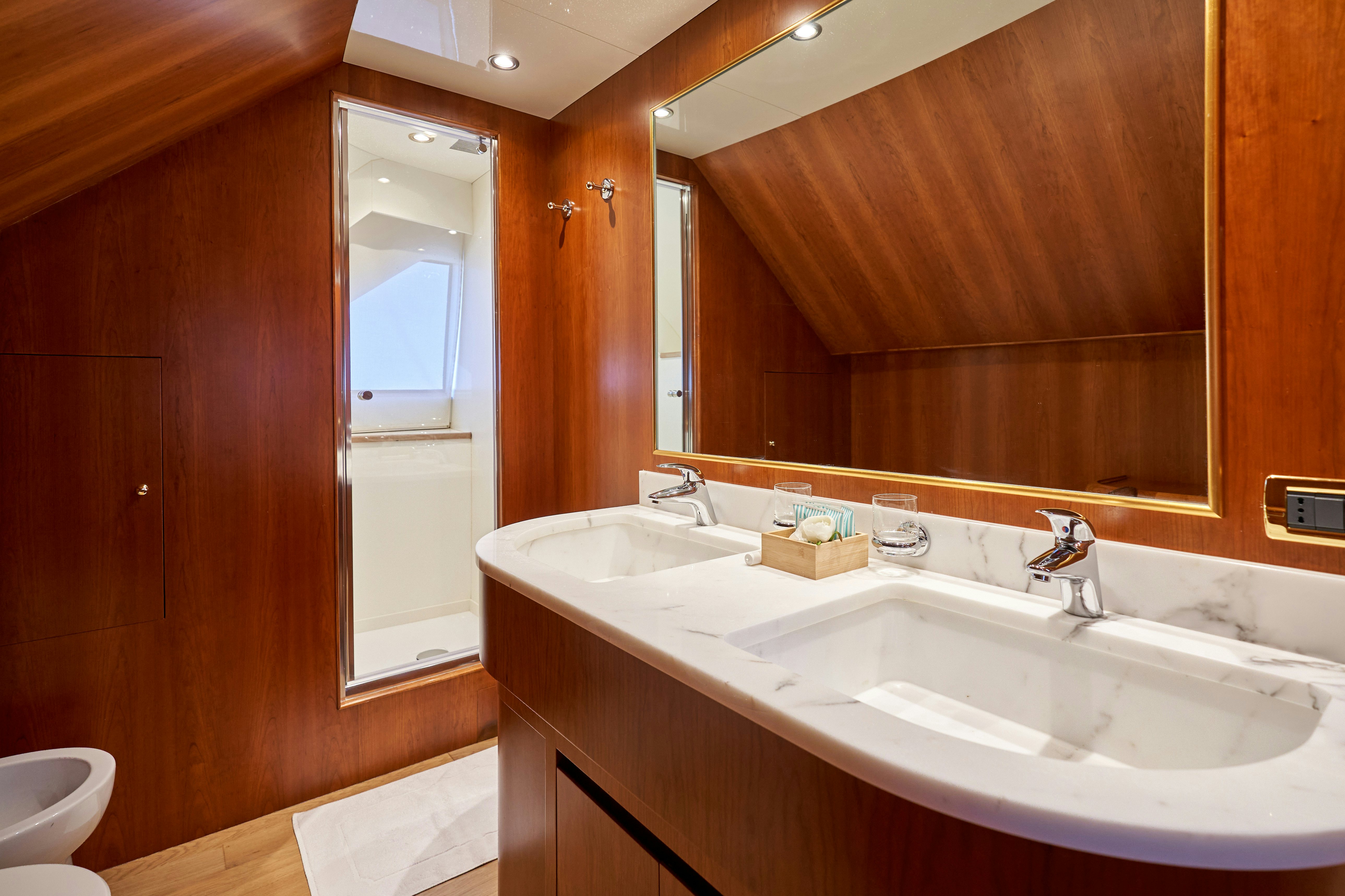 a bathroom with two sinks aboard L'INSTANT IV Yacht for Sale