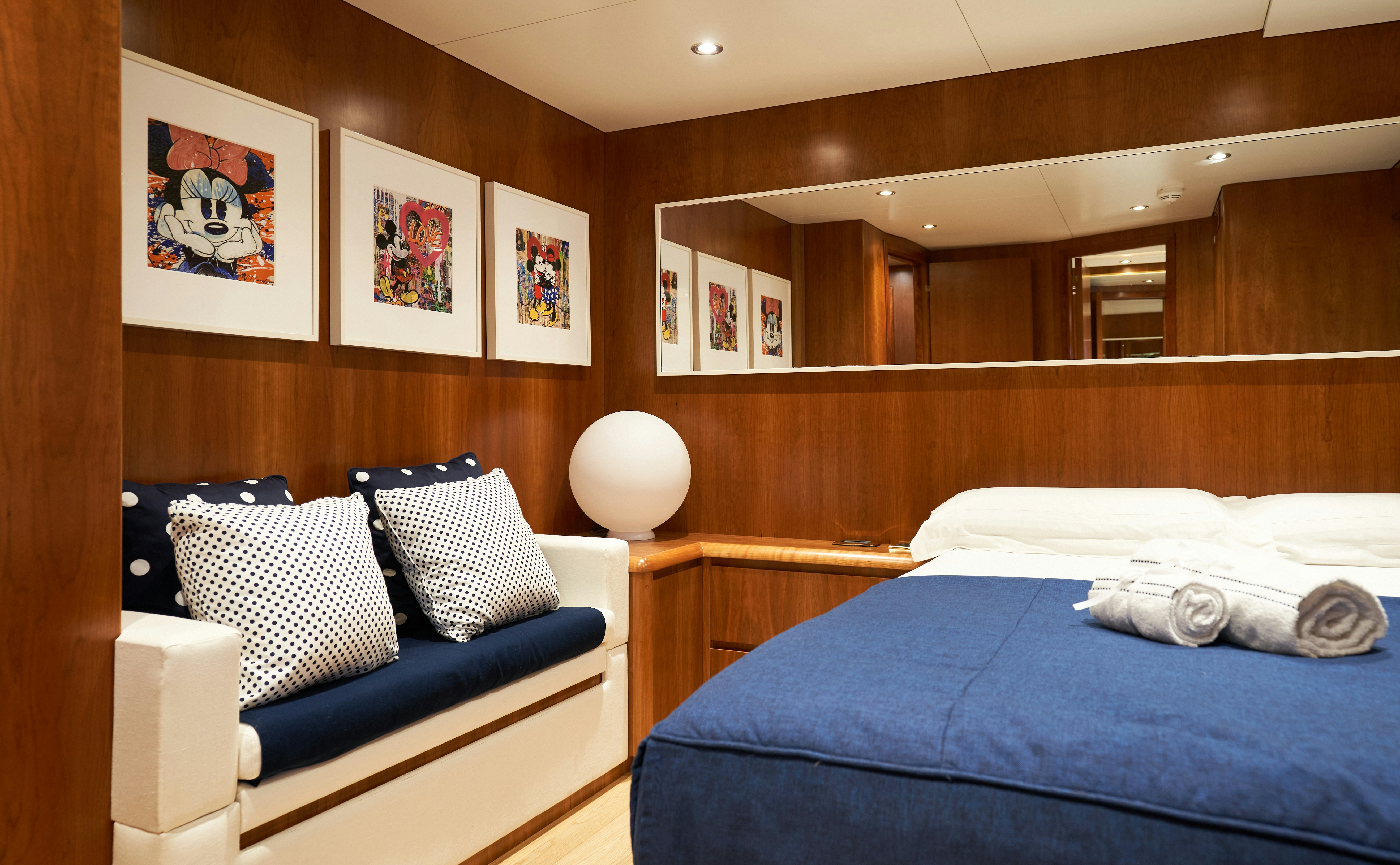 a room with a bed and a blue bed aboard L'INSTANT IV Yacht for Sale