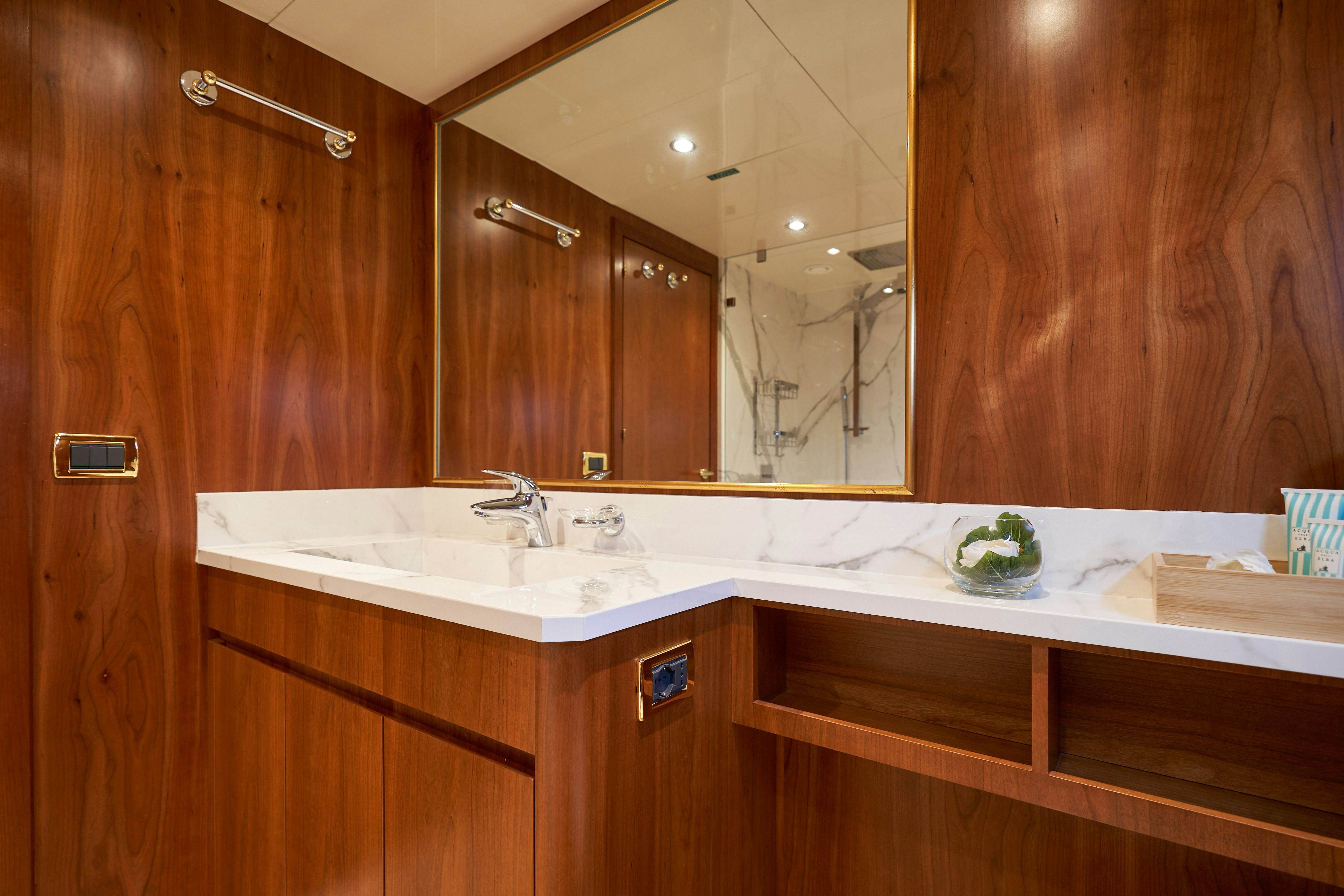 a bathroom with a large mirror aboard L'INSTANT IV Yacht for Sale