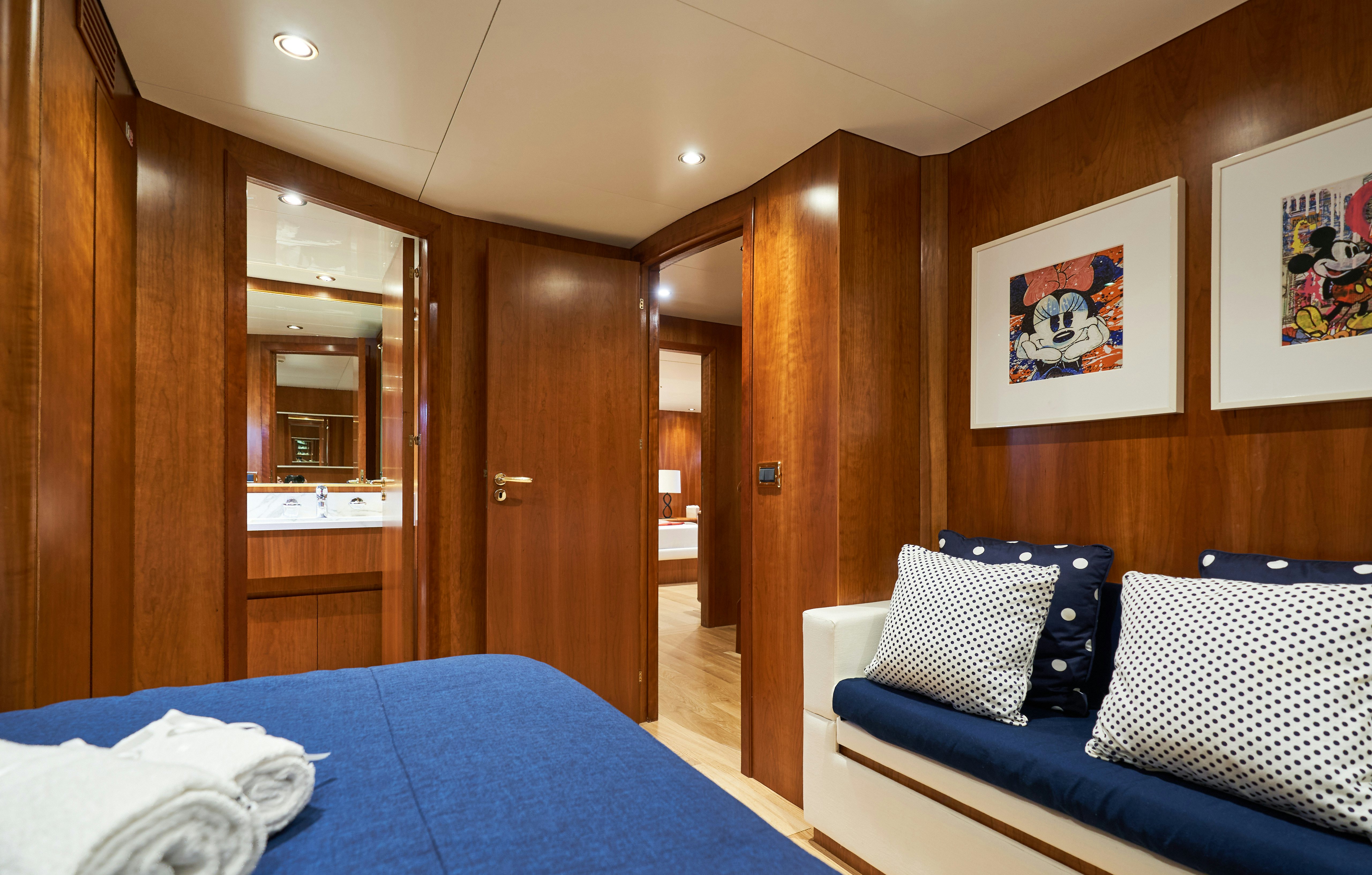 a bedroom with wood walls aboard L'INSTANT IV Yacht for Sale