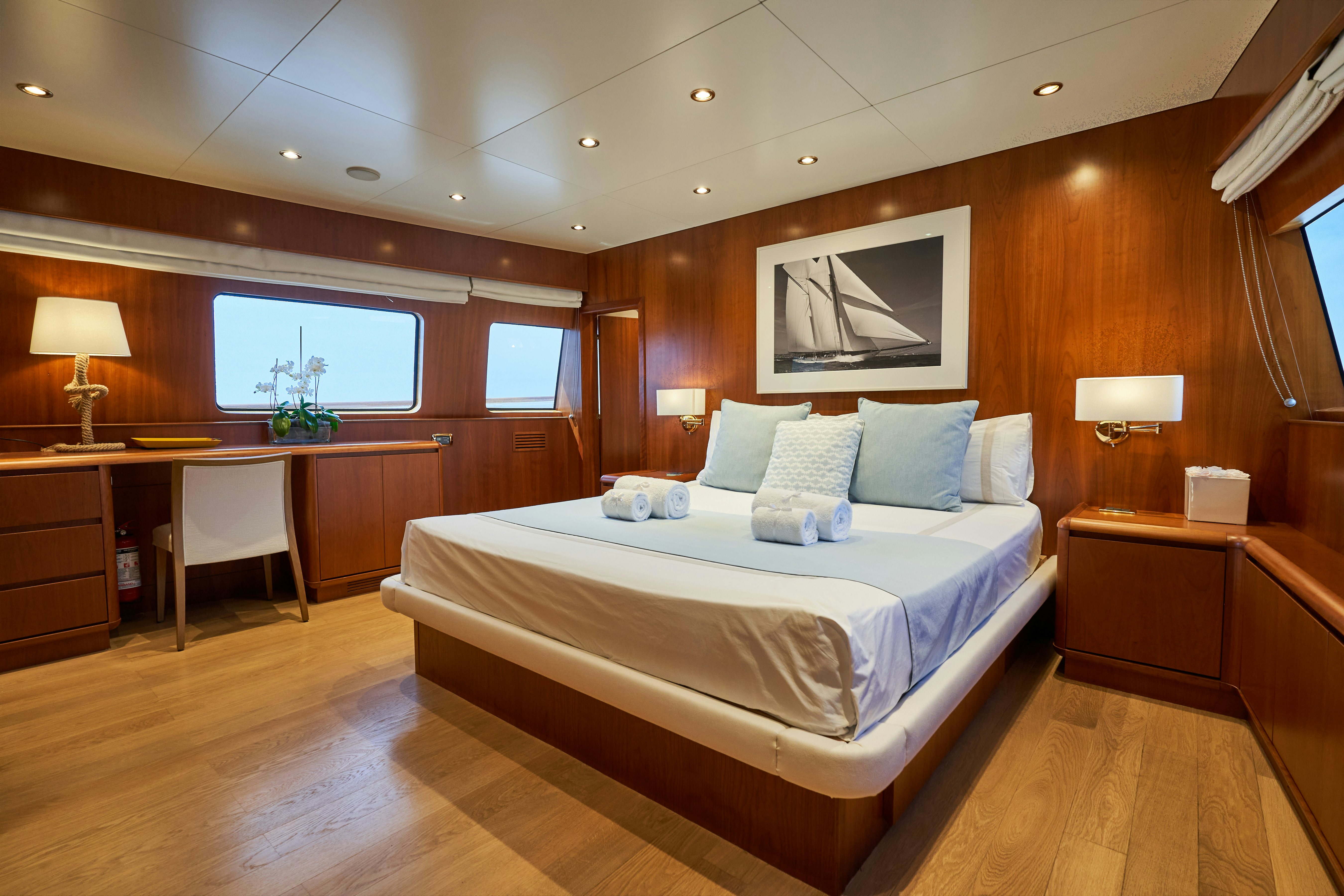 a large bedroom with a large bed aboard L'INSTANT IV Yacht for Sale