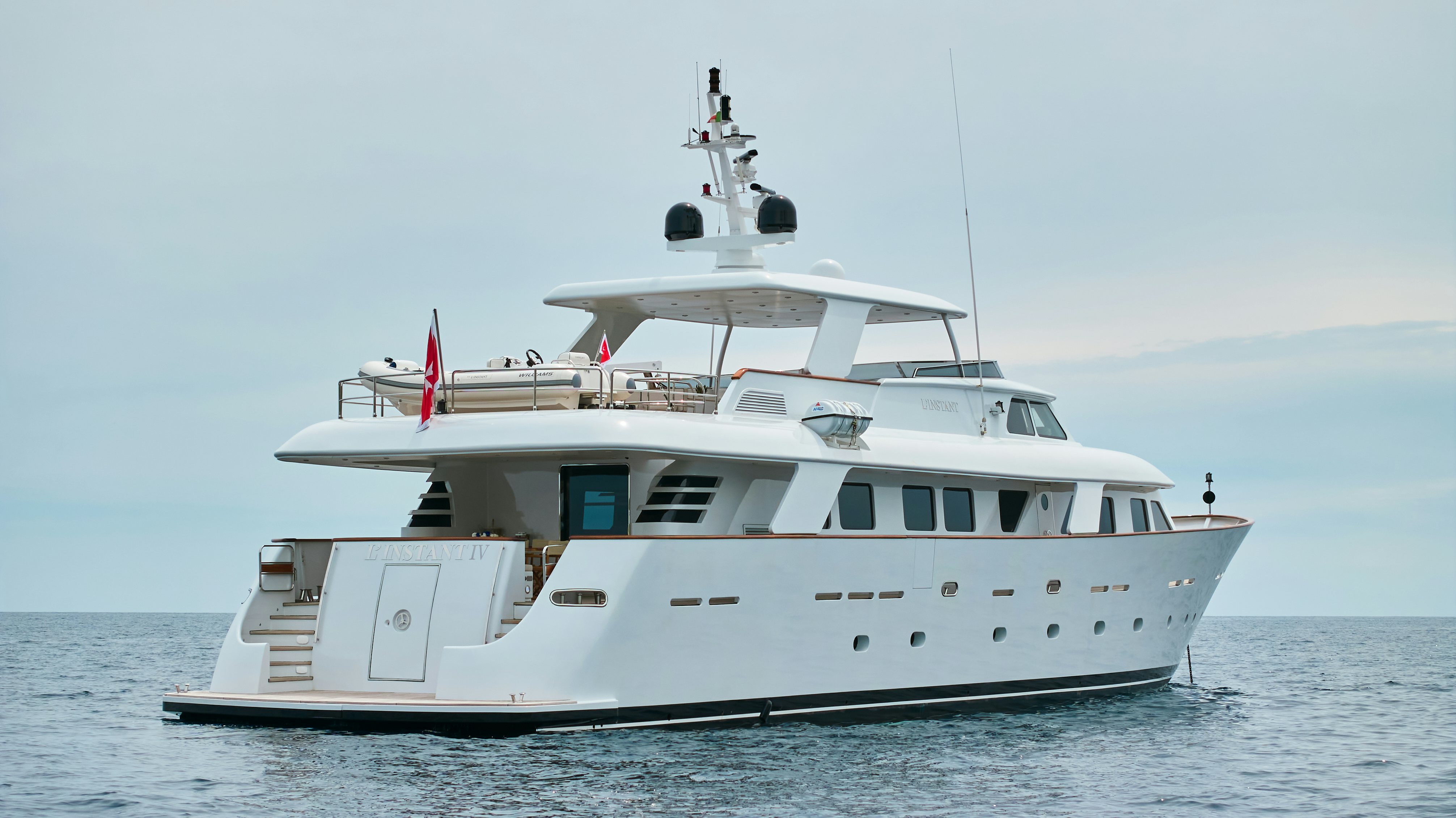 a white yacht in the water aboard L'INSTANT IV Yacht for Sale
