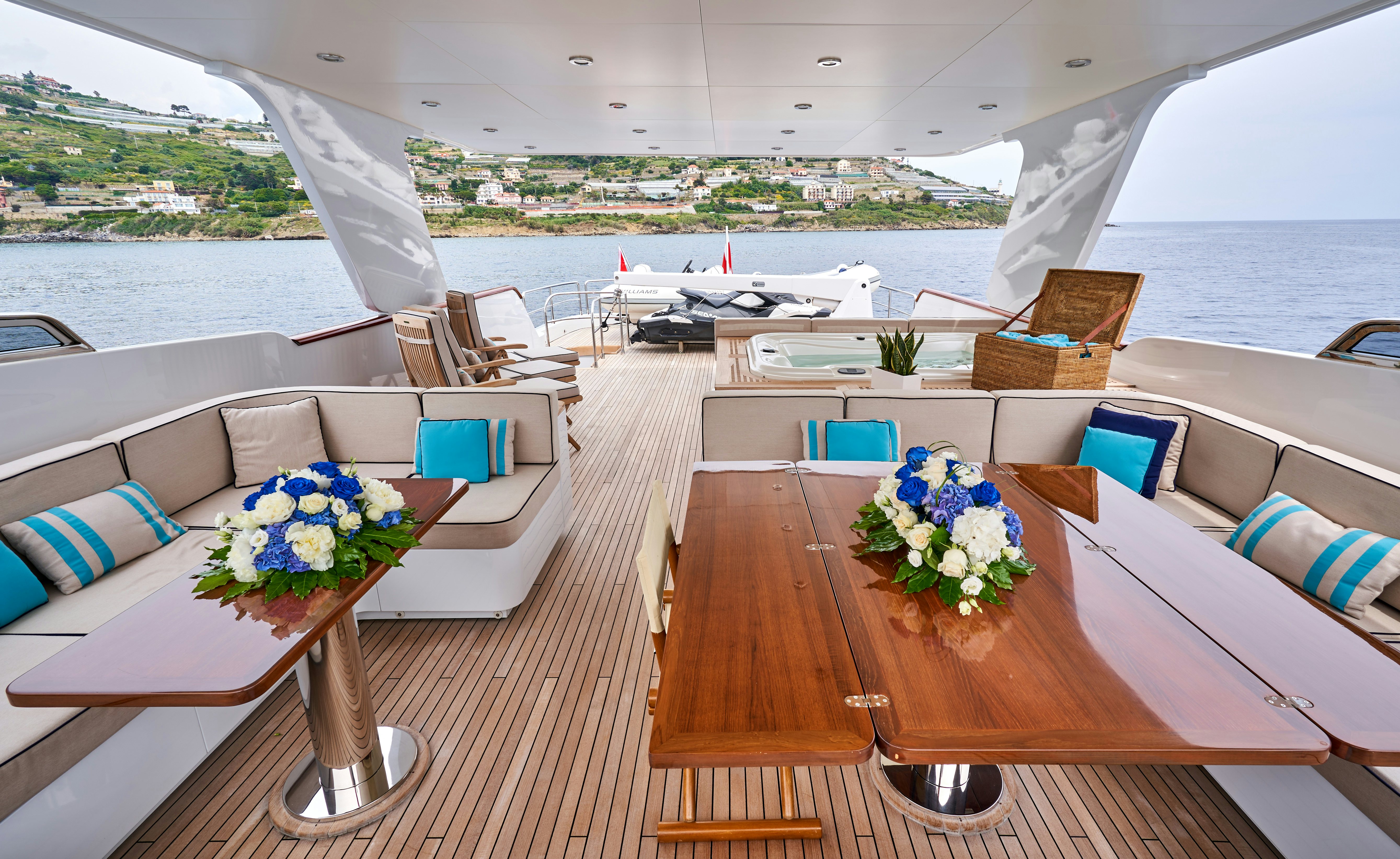 a table with chairs on it next to a body of water aboard L'INSTANT IV Yacht for Sale