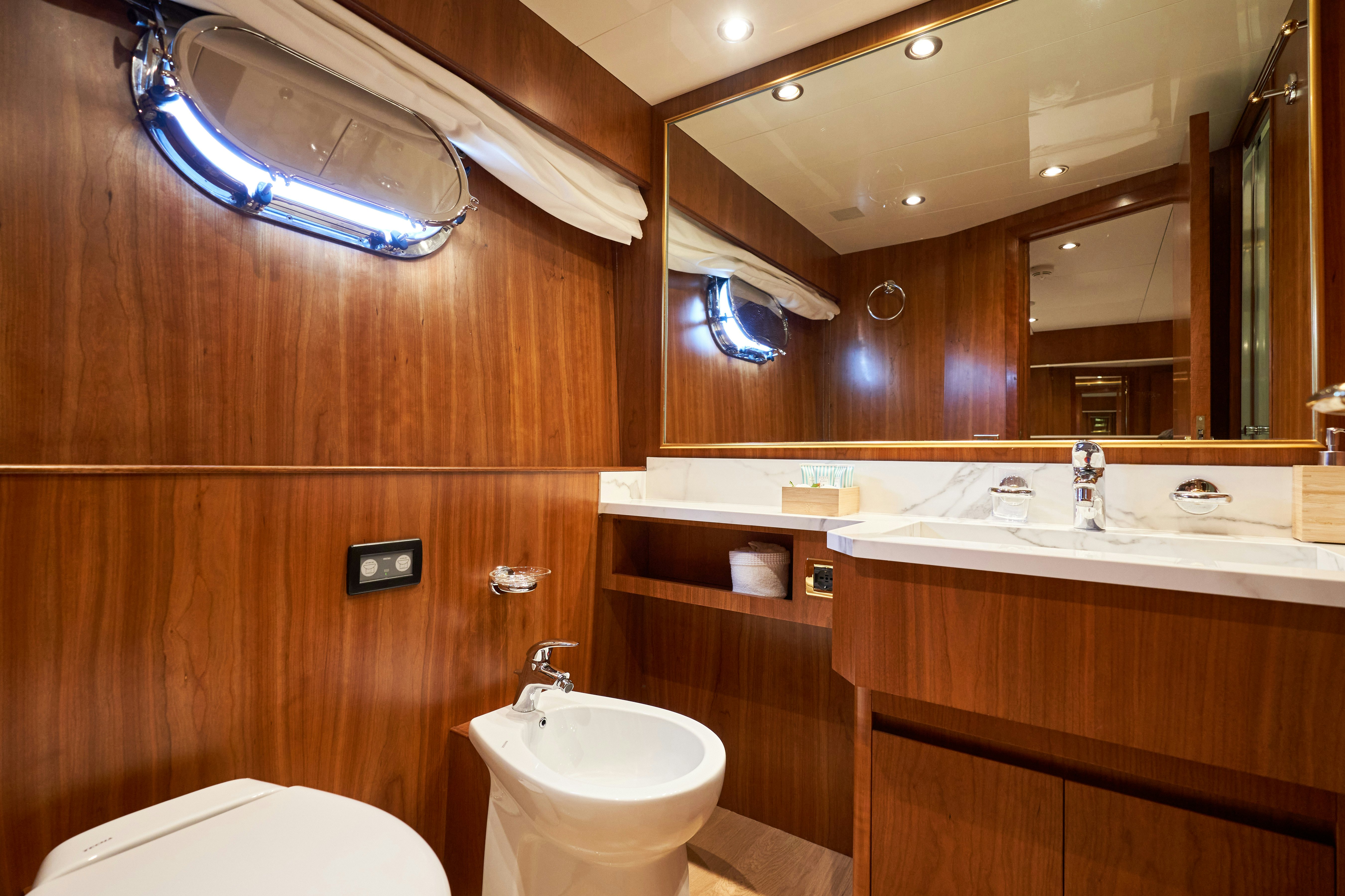 a bathroom with a sink and a toilet aboard L'INSTANT IV Yacht for Sale