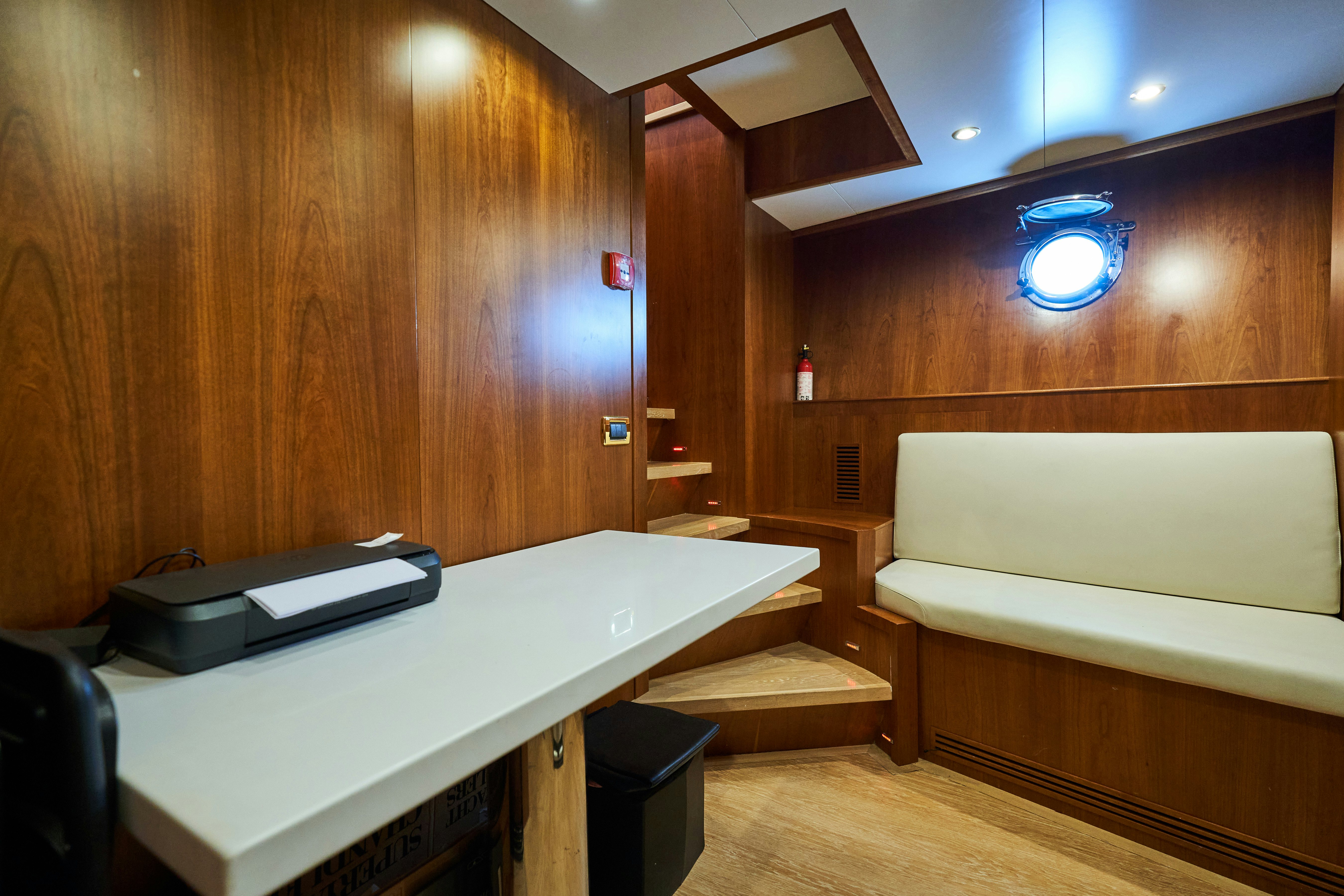 a room with a bed and a desk aboard L'INSTANT IV Yacht for Sale