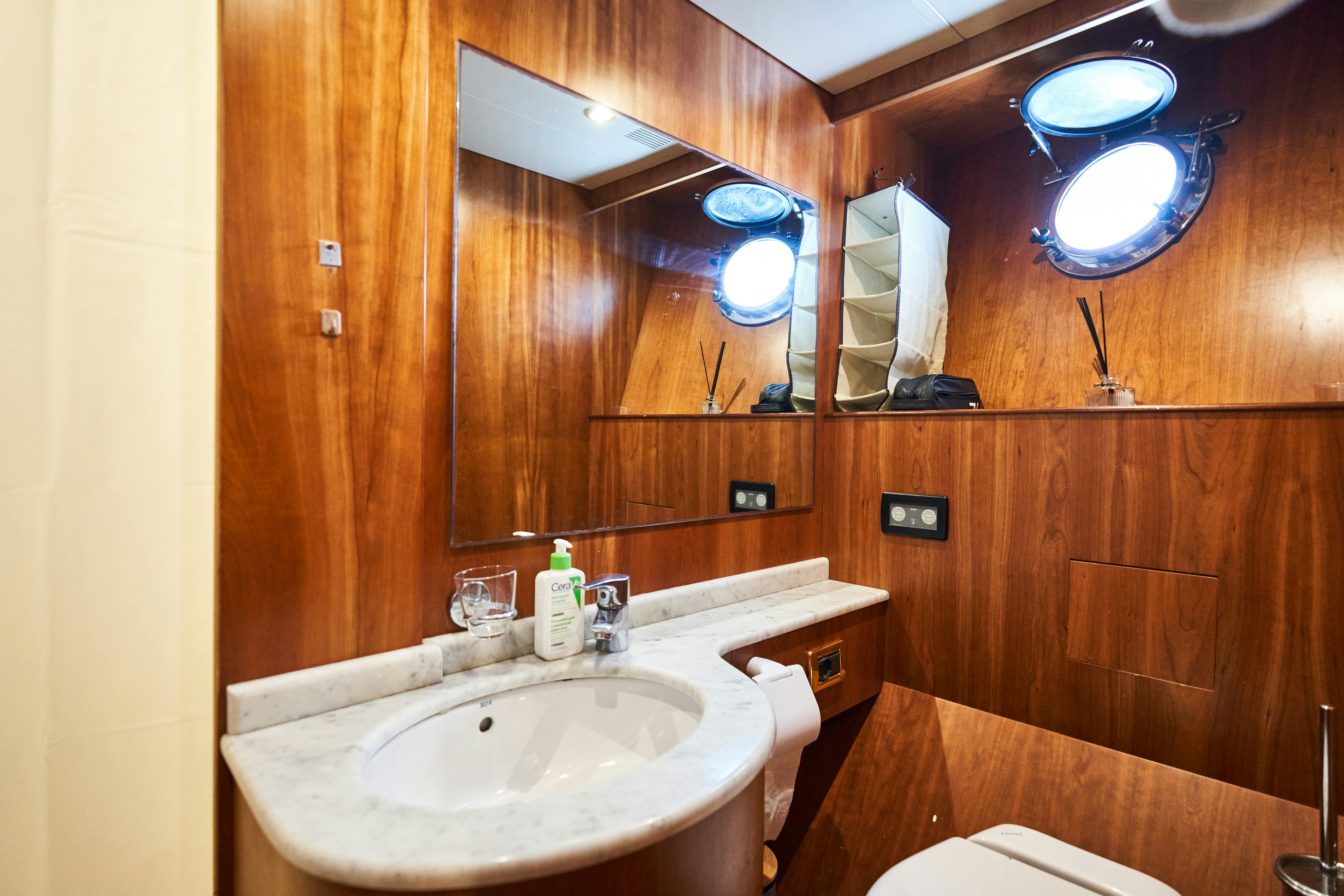 a bathroom with a sink and a mirror aboard L'INSTANT IV Yacht for Sale