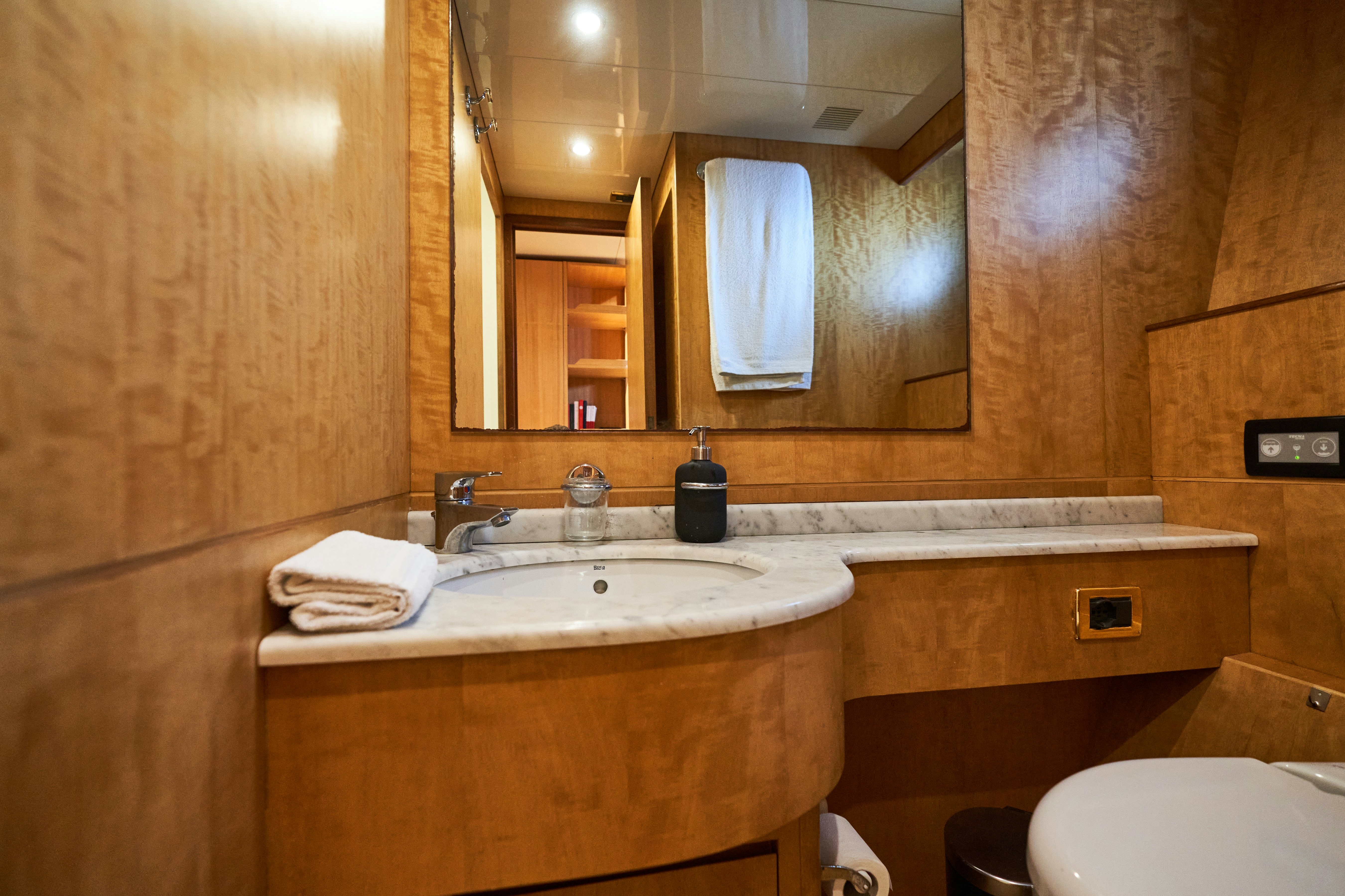 a bathroom with a sink and a mirror aboard L'INSTANT IV Yacht for Sale