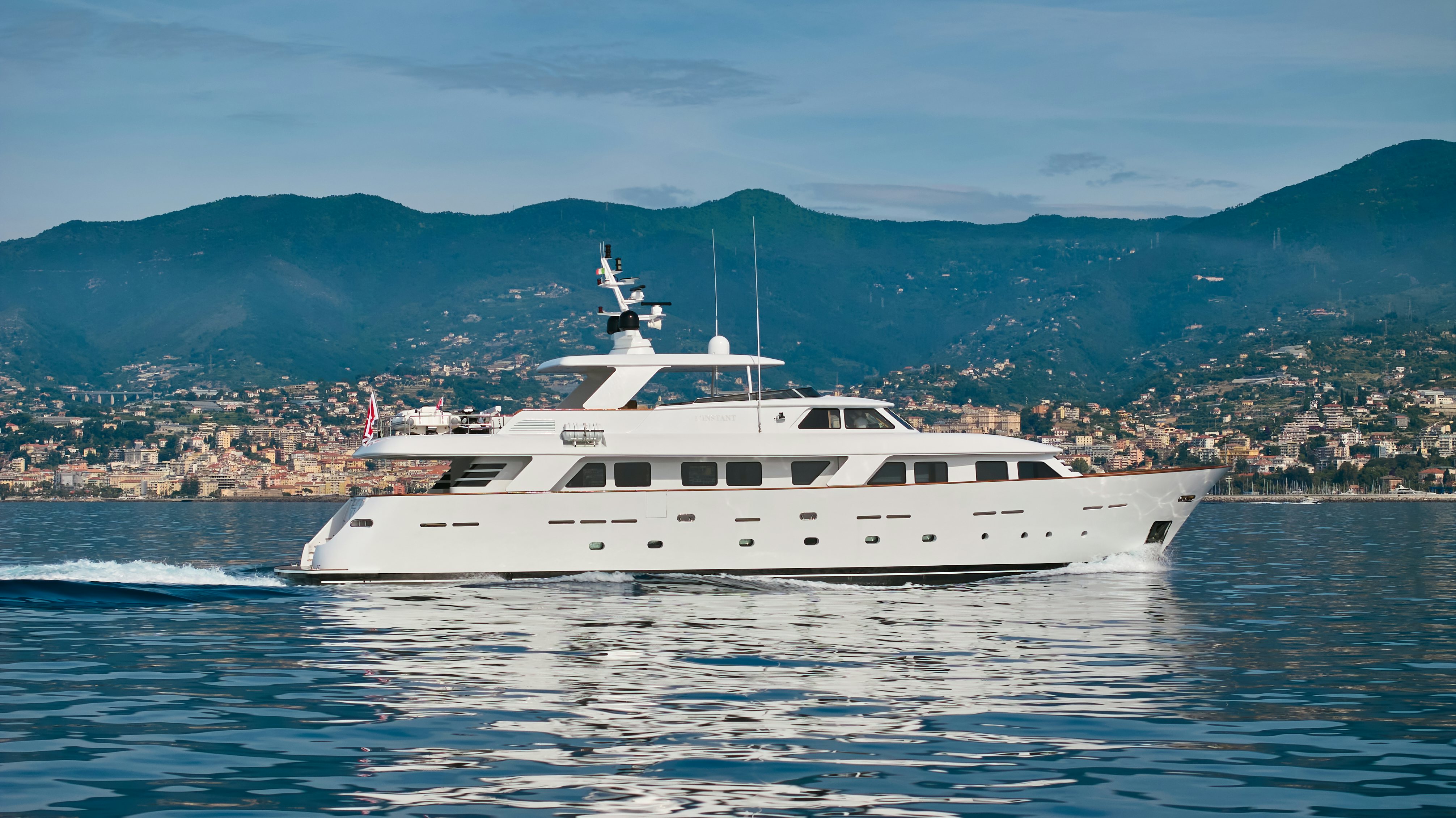 a white yacht on the water aboard L'INSTANT IV Yacht for Sale