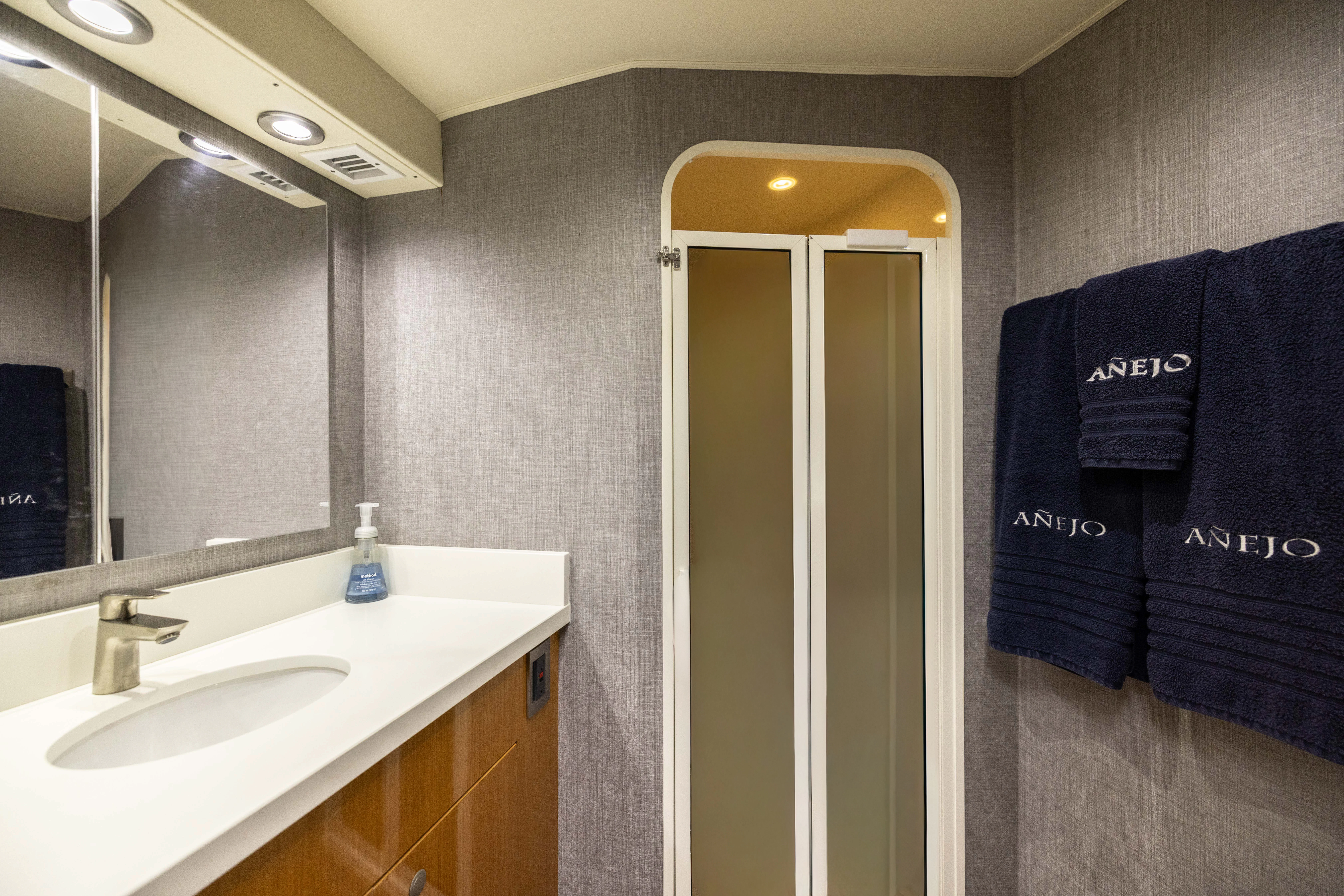 a bathroom with a blue towel on the wall aboard ANEJO Yacht for Sale