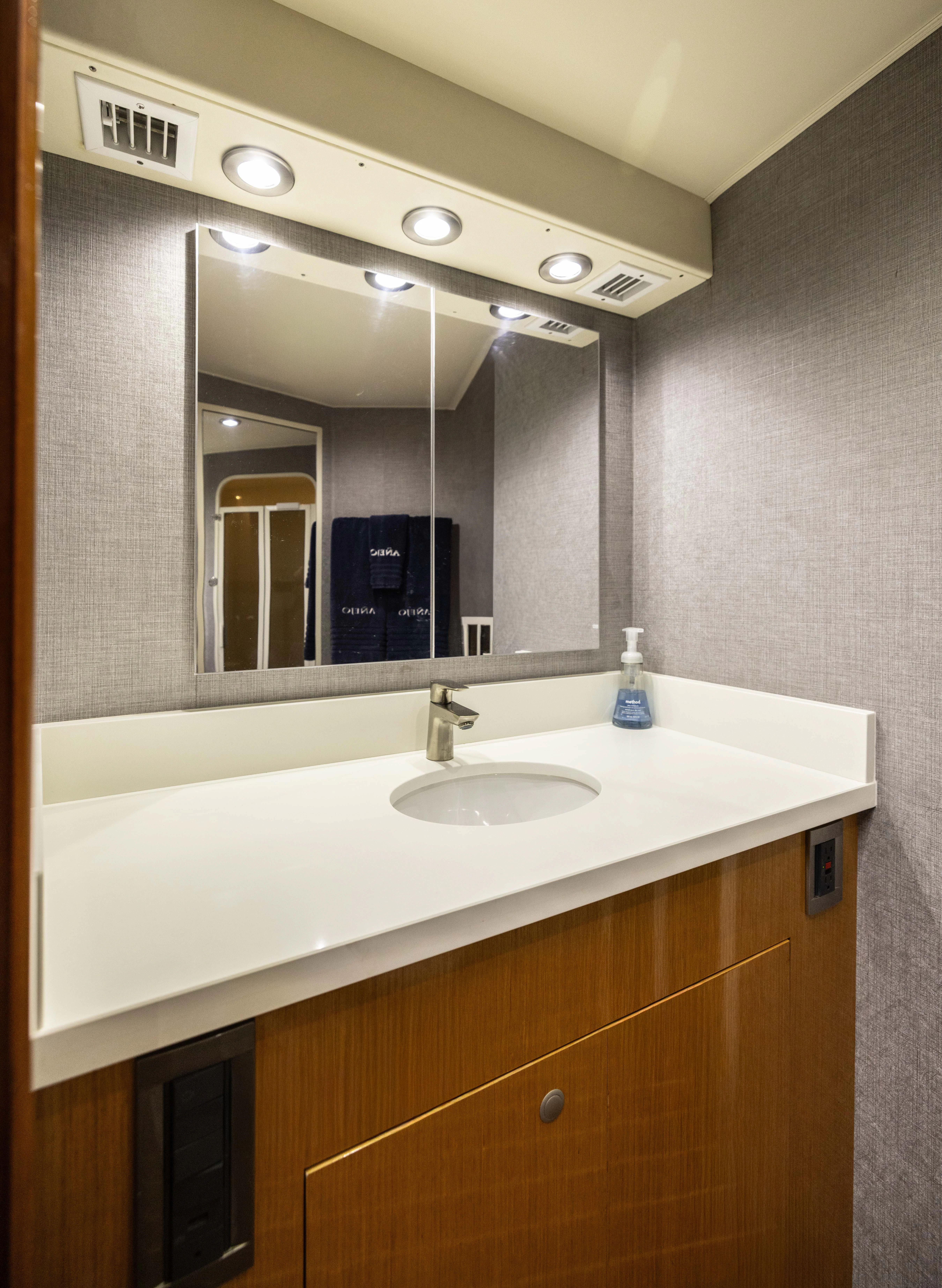 a bathroom with a large mirror aboard ANEJO Yacht for Sale