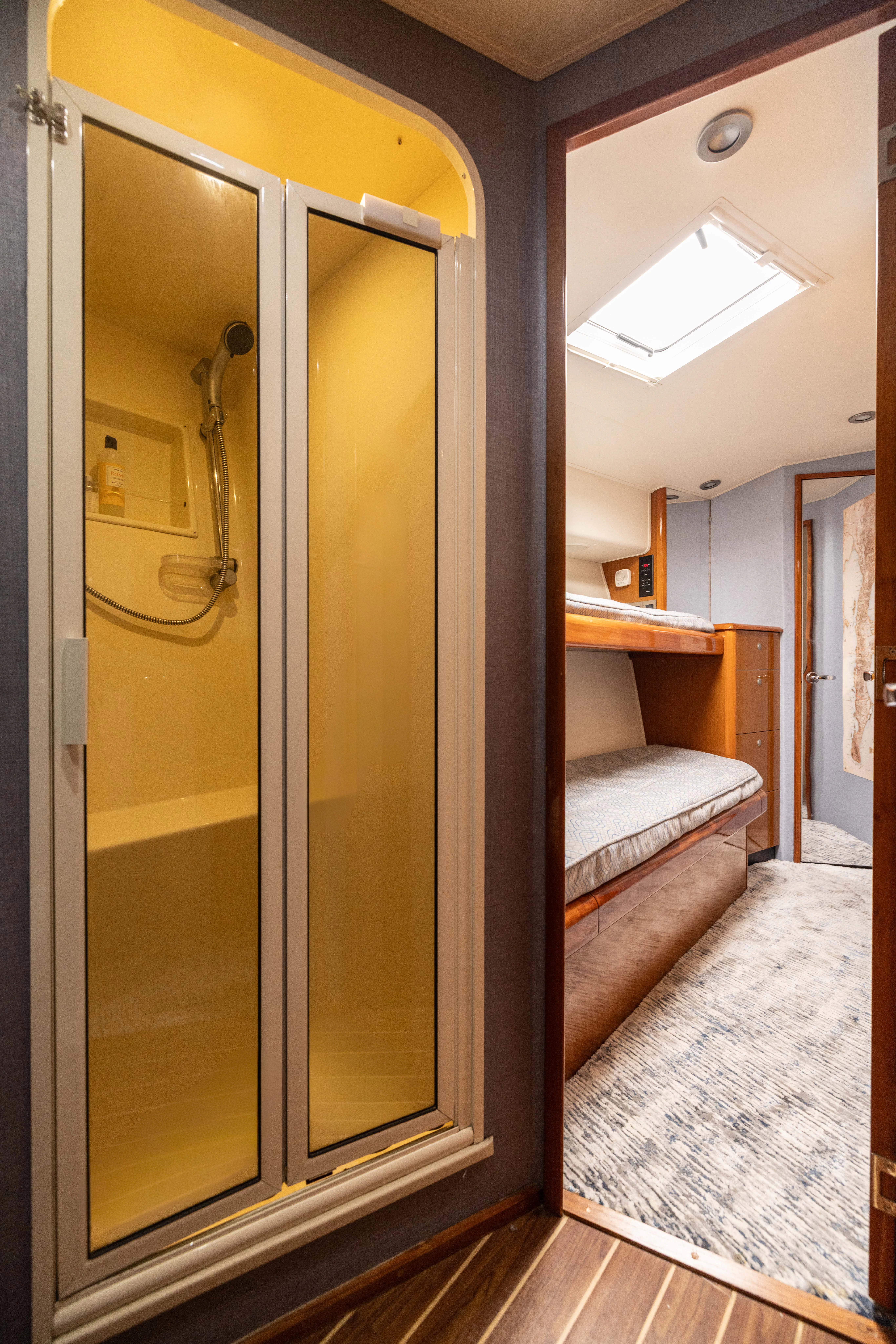 a bathroom with a glass shower aboard ANEJO Yacht for Sale
