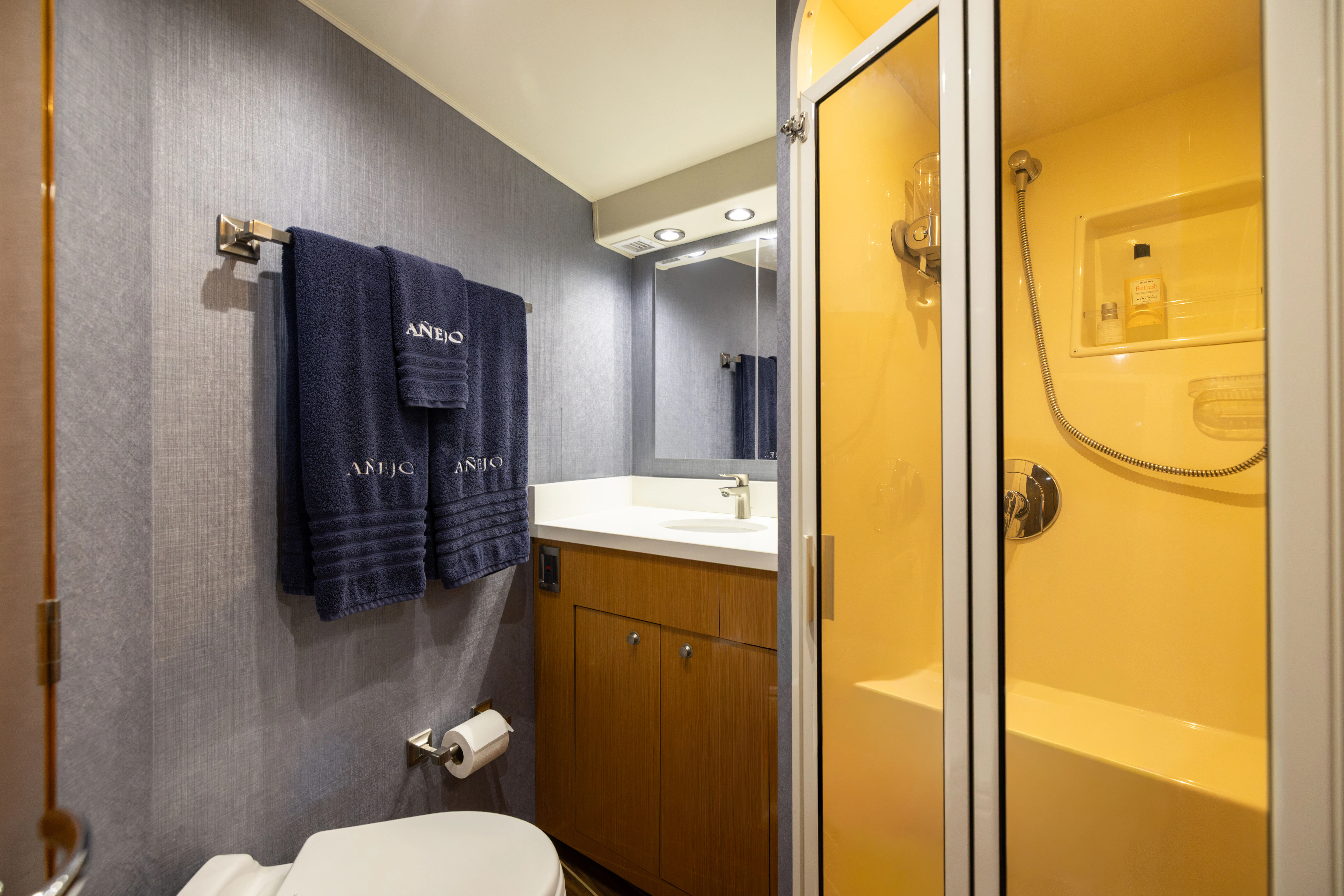 a bathroom with a glass shower aboard ANEJO Yacht for Sale
