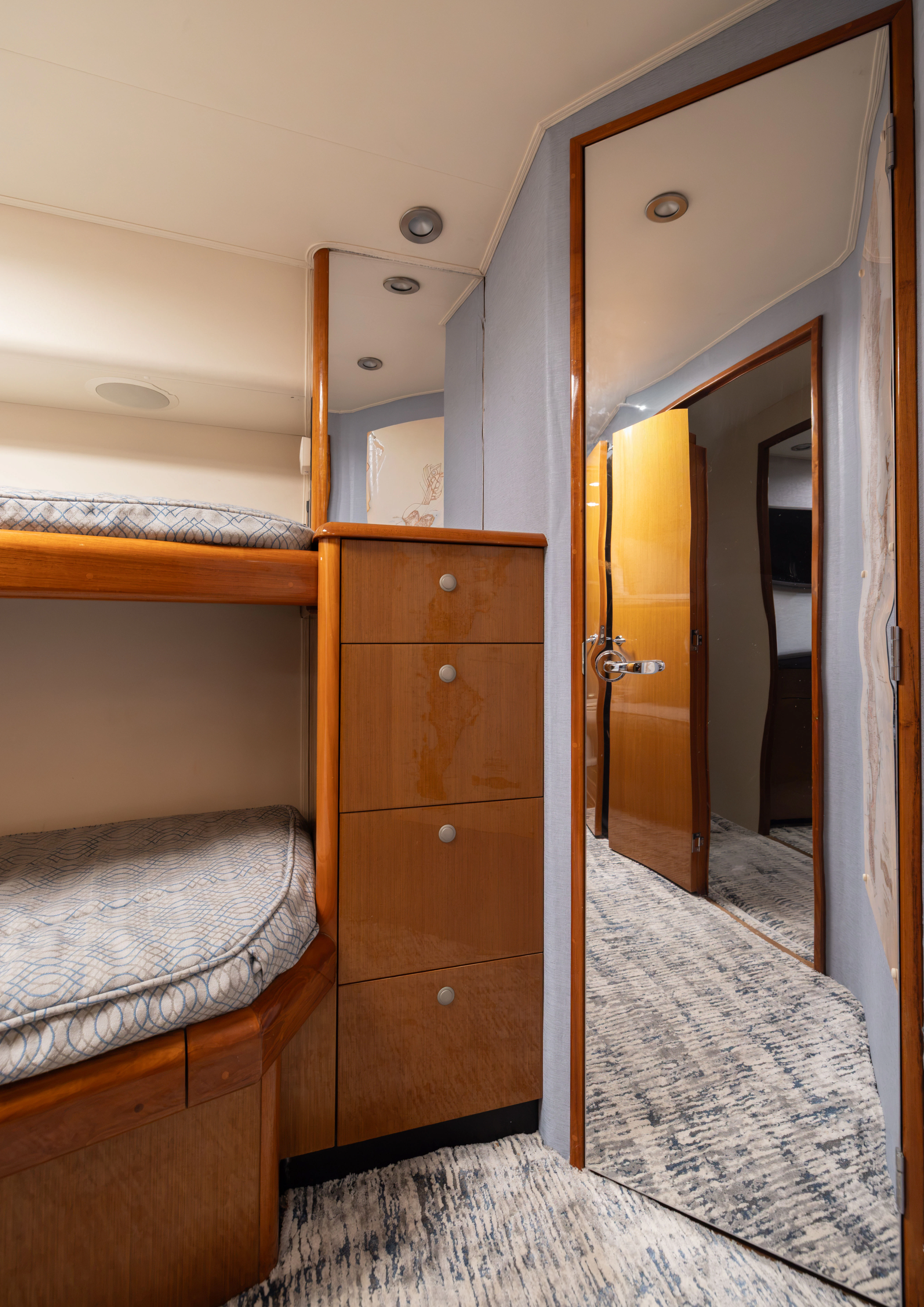 a bedroom with a bed and a mirror aboard ANEJO Yacht for Sale