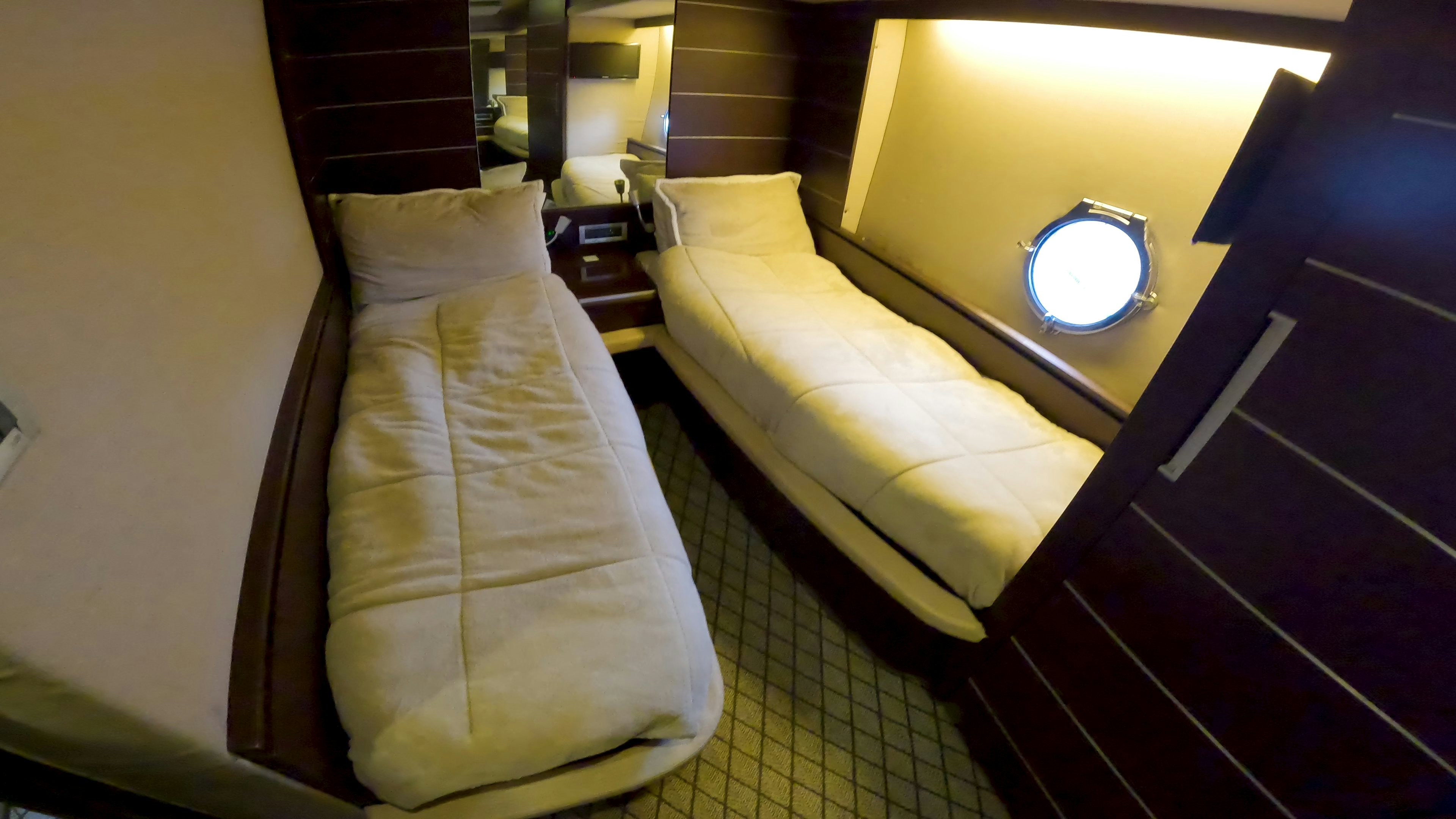 a hotel room with a bed and a round mirror aboard BOAT Yacht for Sale