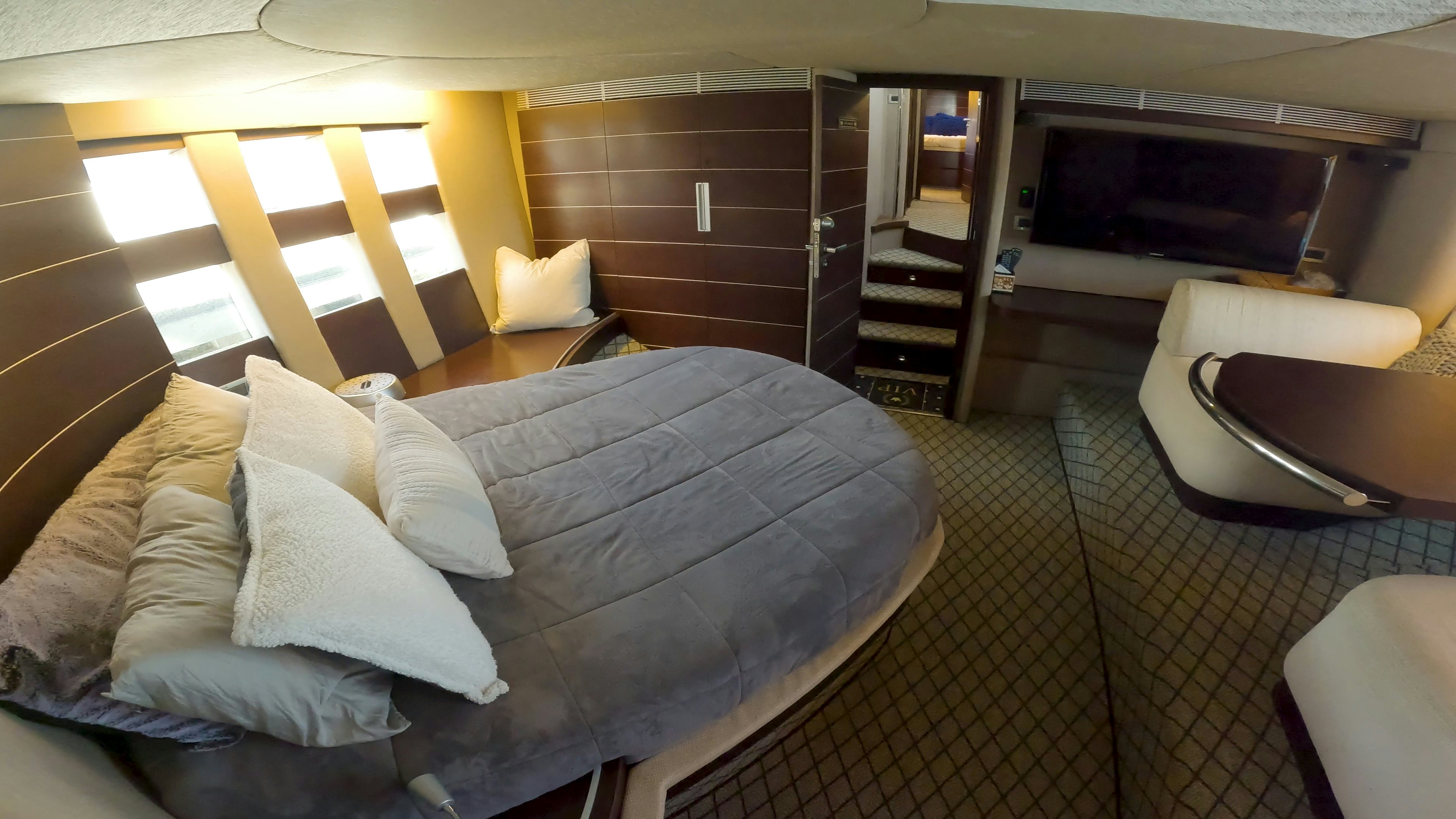 a room with a bed and a fireplace aboard BOAT Yacht for Sale