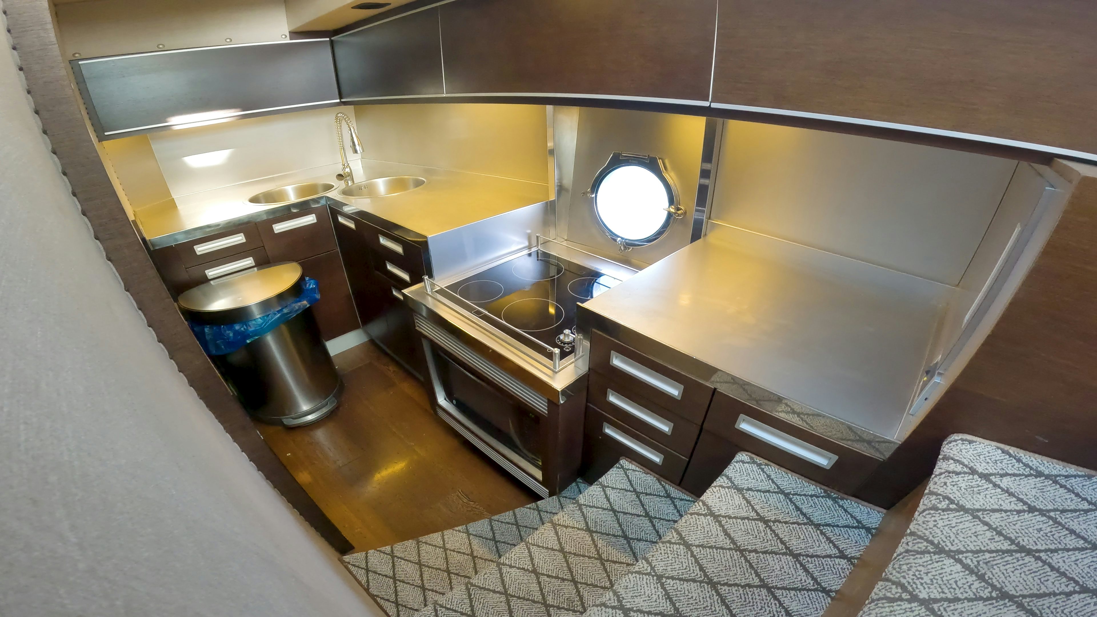 a kitchen with a large round mirror aboard BOAT Yacht for Sale