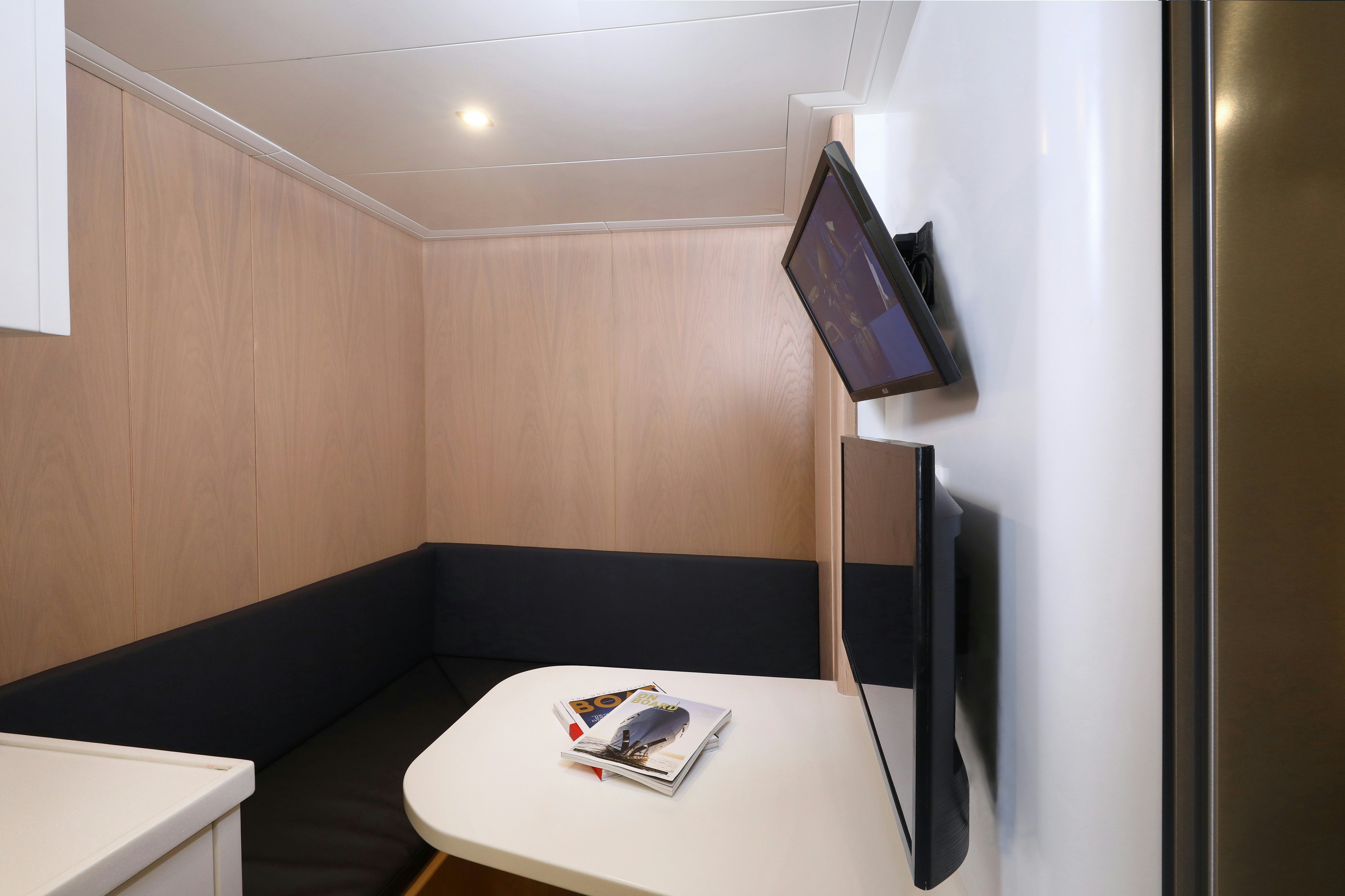 a room with a couch and a tv aboard AEGEAN EXPLORER 26M HULL #3 Yacht for Sale