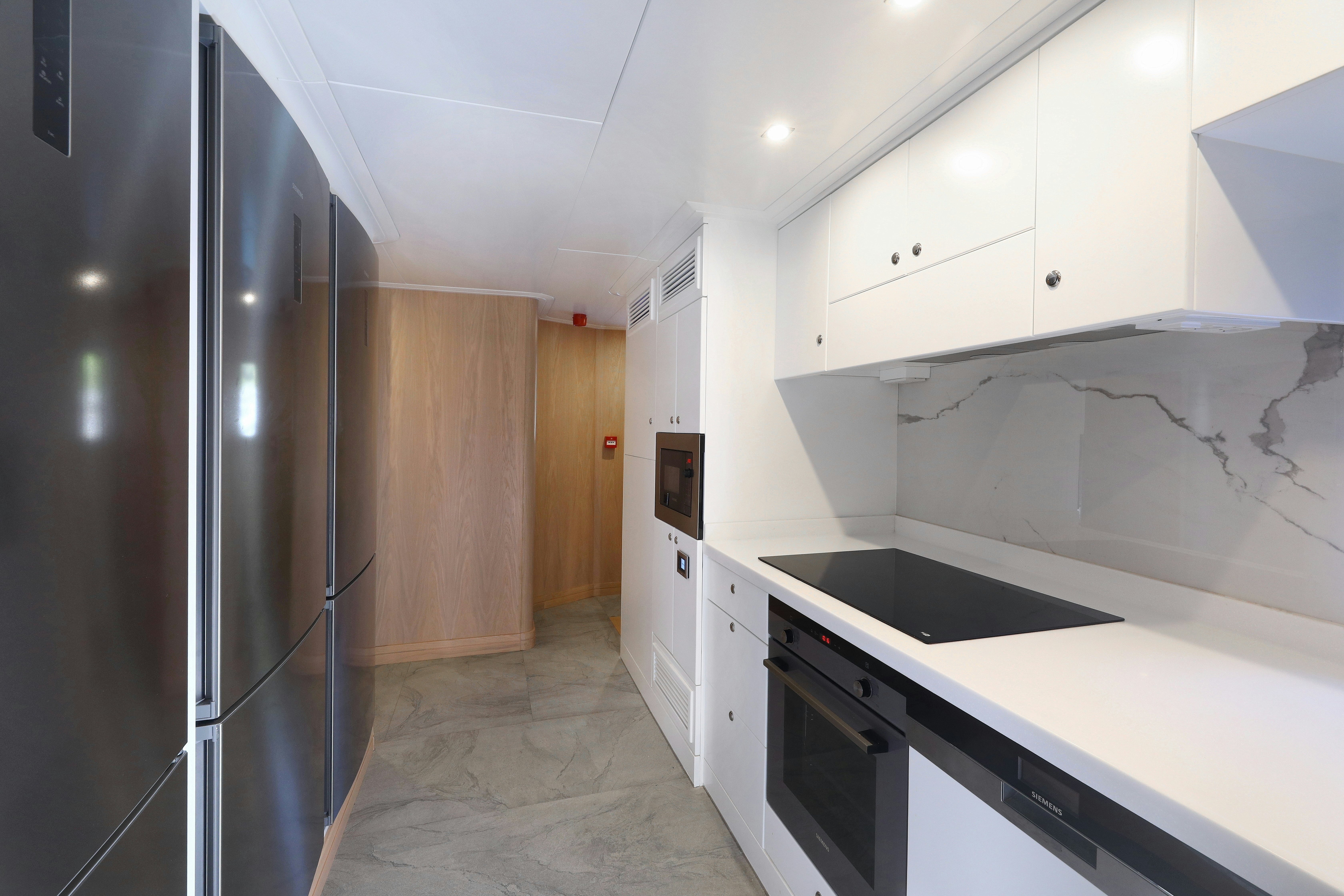 a kitchen with a stainless steel refrigerator aboard AEGEAN EXPLORER 26M HULL #3 Yacht for Sale