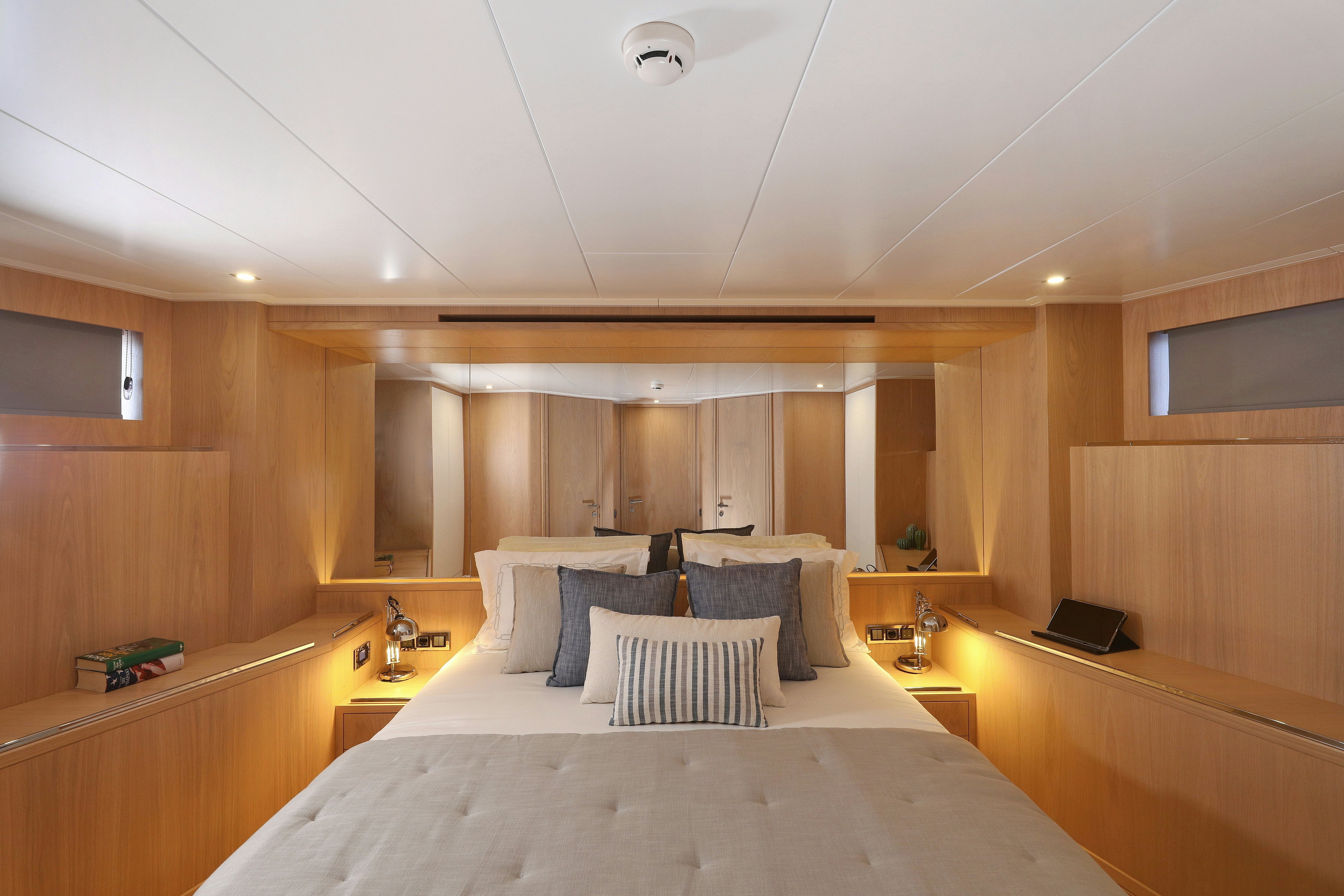 a large hotel room with a bed aboard AEGEAN EXPLORER 26M HULL #3 Yacht for Sale