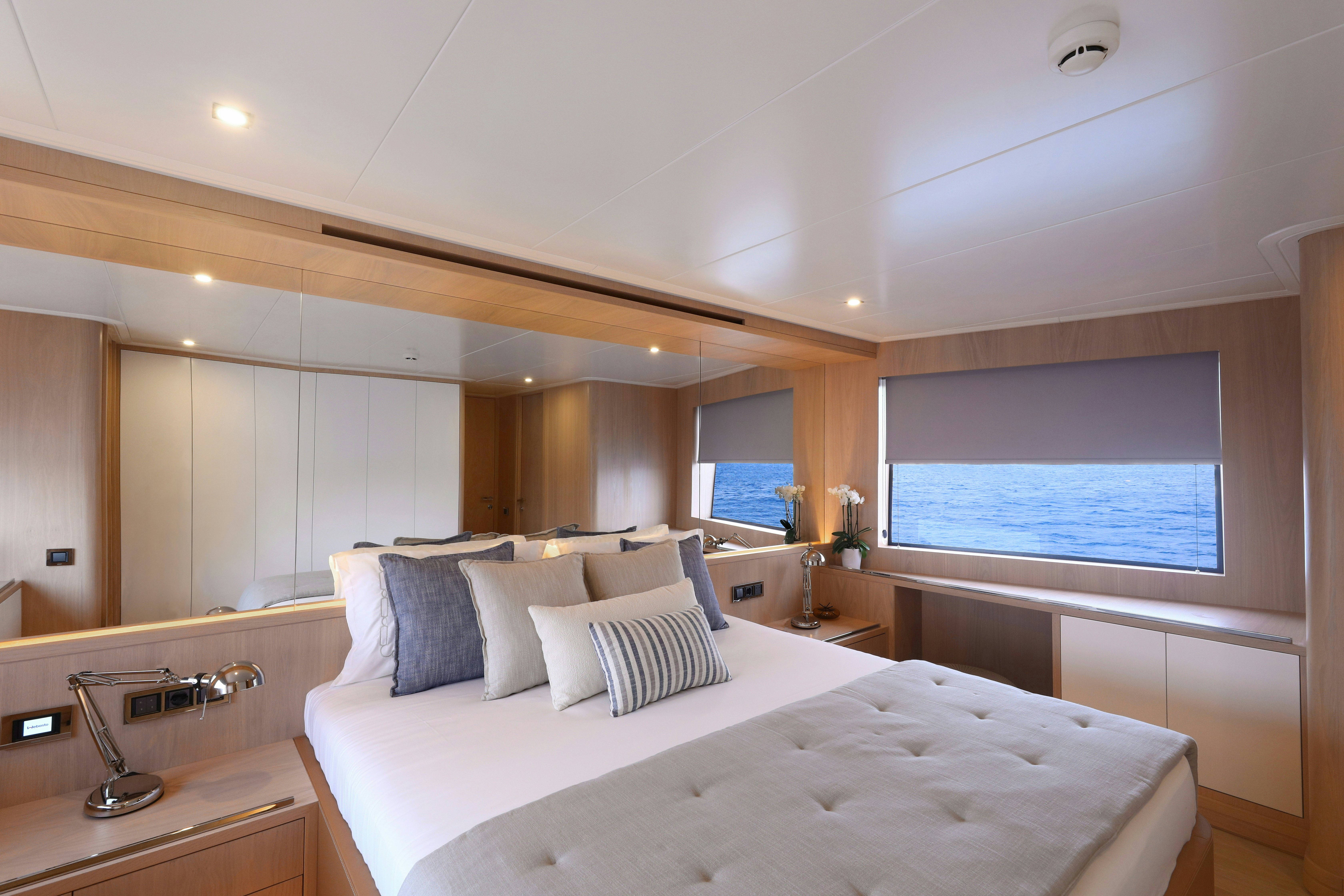 a room with a bed and a window aboard AEGEAN EXPLORER 26M HULL #3 Yacht for Sale