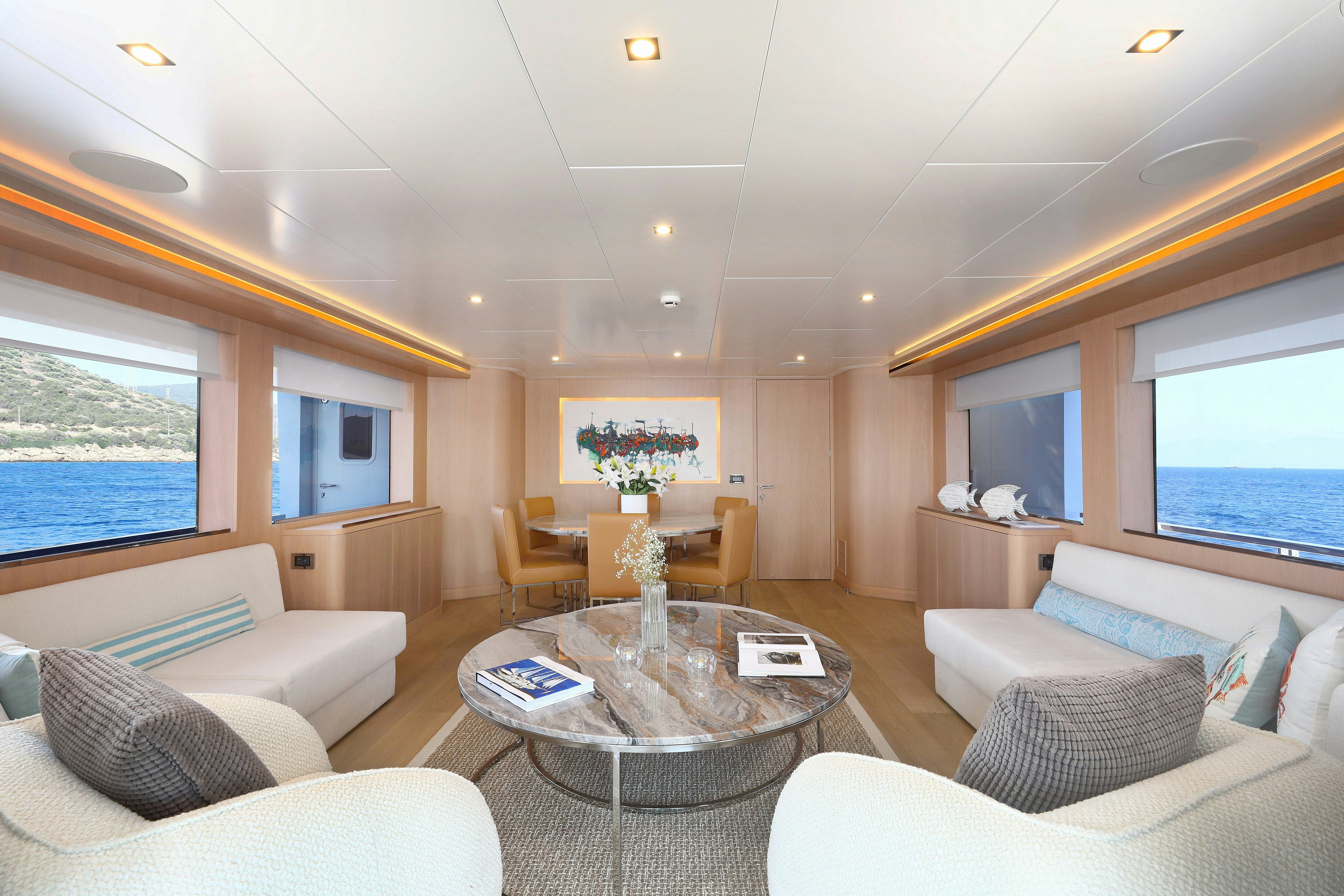 a living room with a large window aboard AEGEAN EXPLORER 26M HULL #3 Yacht for Sale