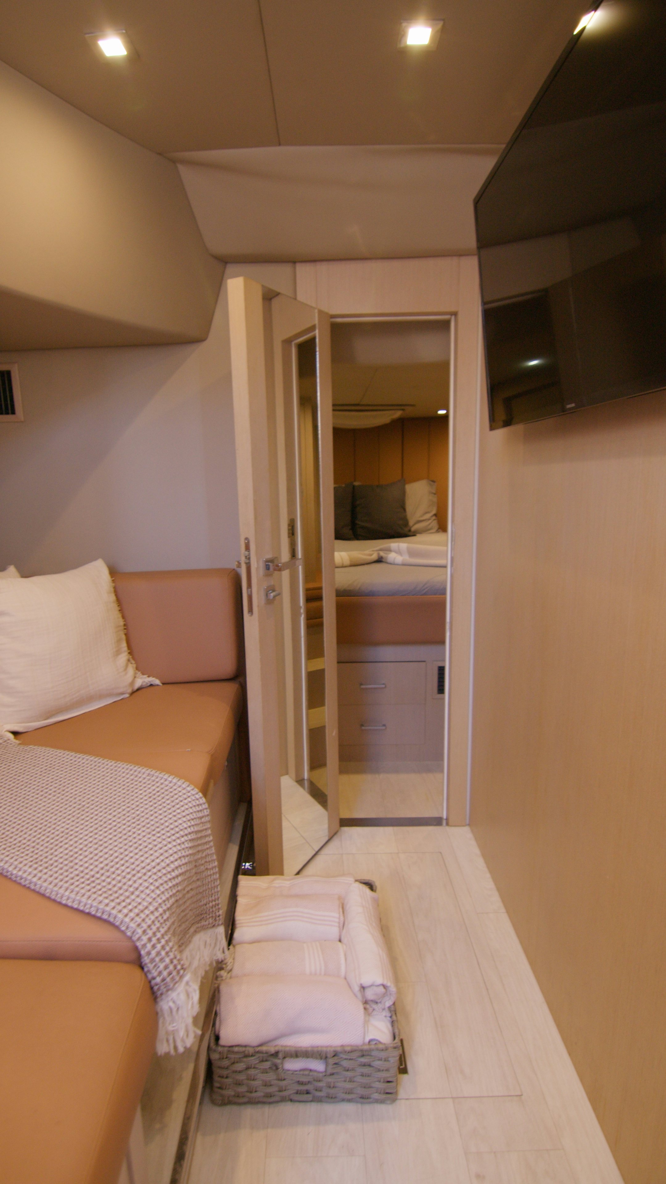 a room with a bed and a mirror aboard QUIKWOOD Yacht for Sale