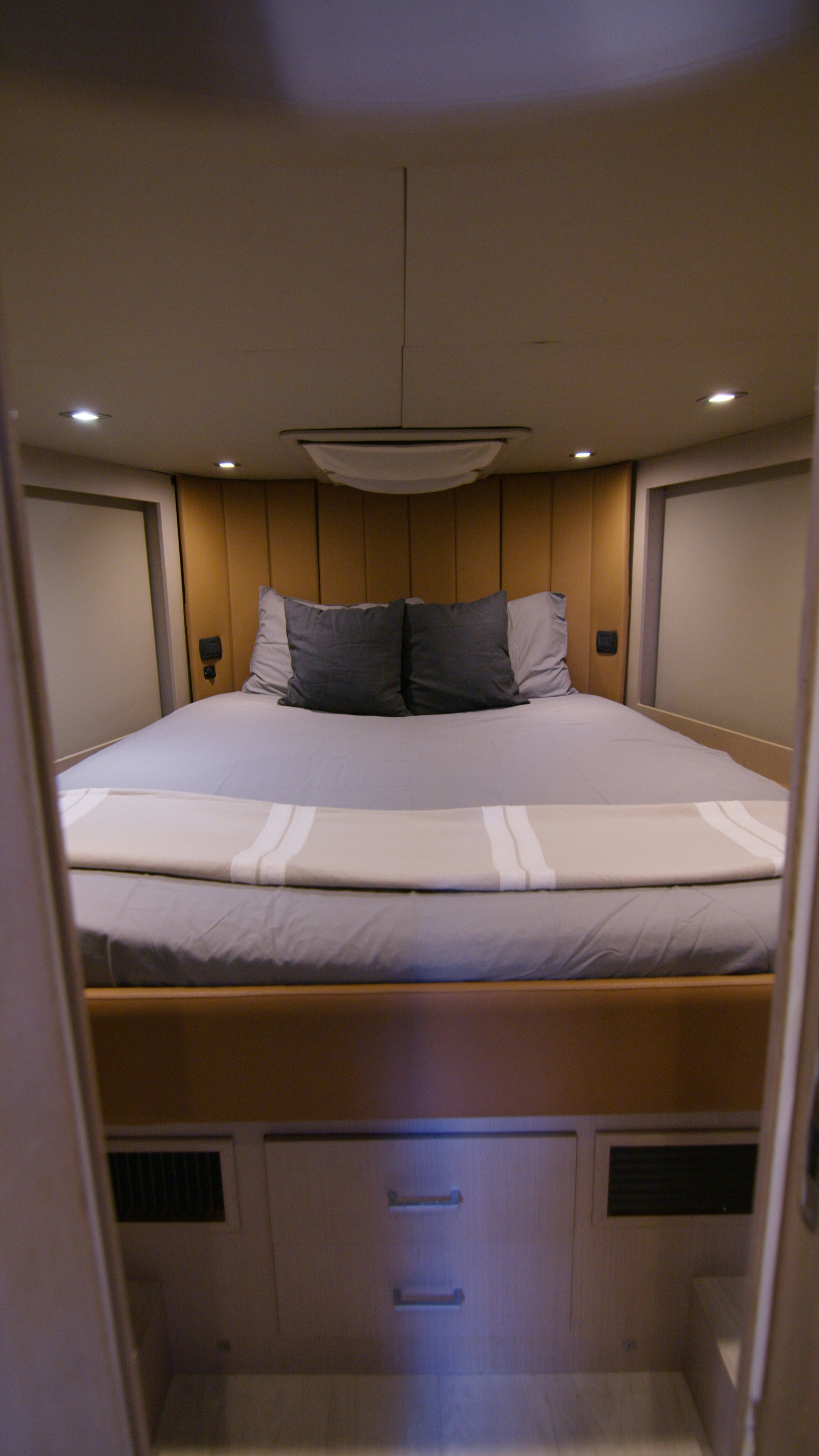 a bed with a white bed spread aboard QUIKWOOD Yacht for Sale