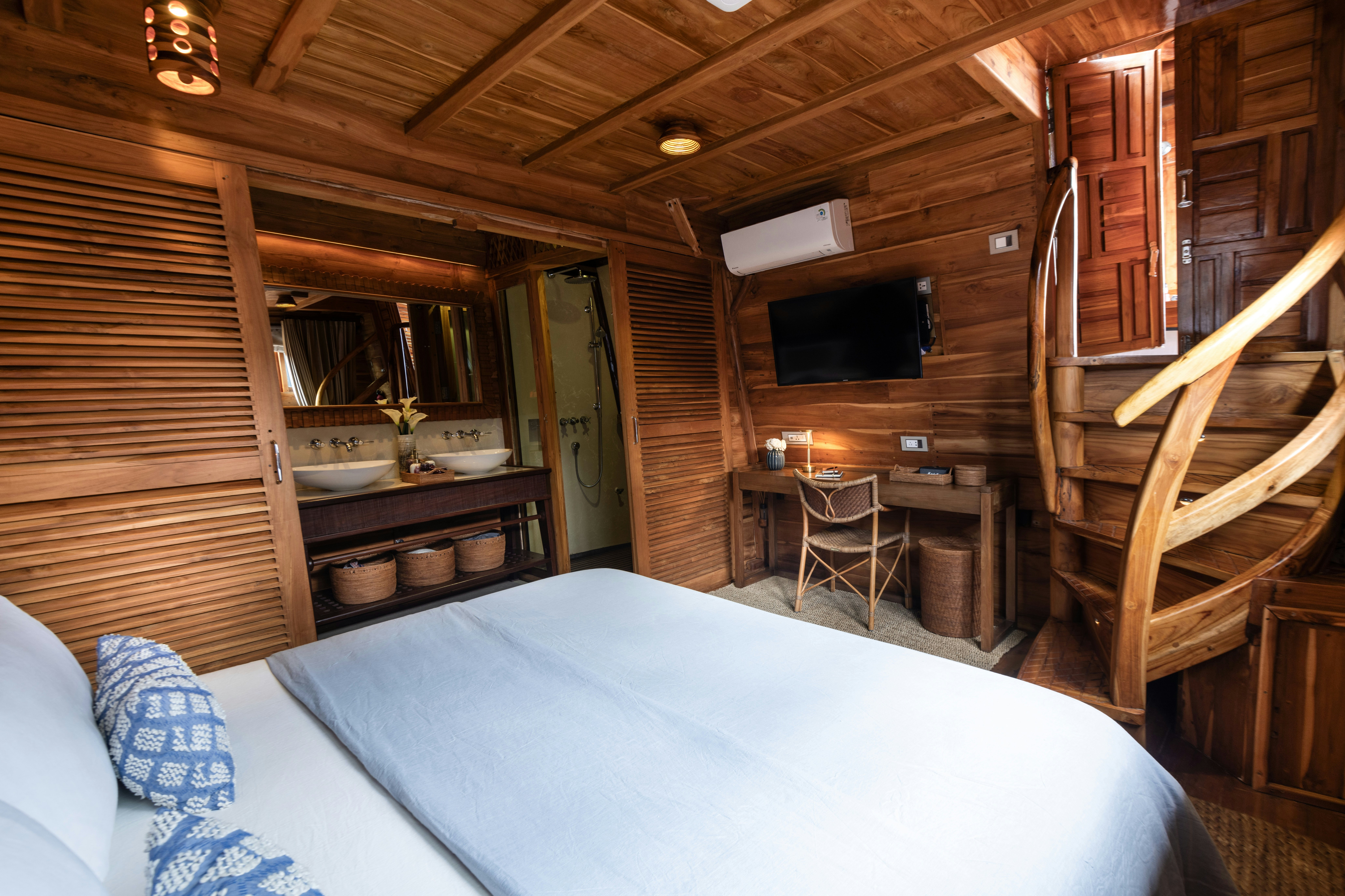a cabin with a bed and a television aboard SEQUOIA Yacht for Charter