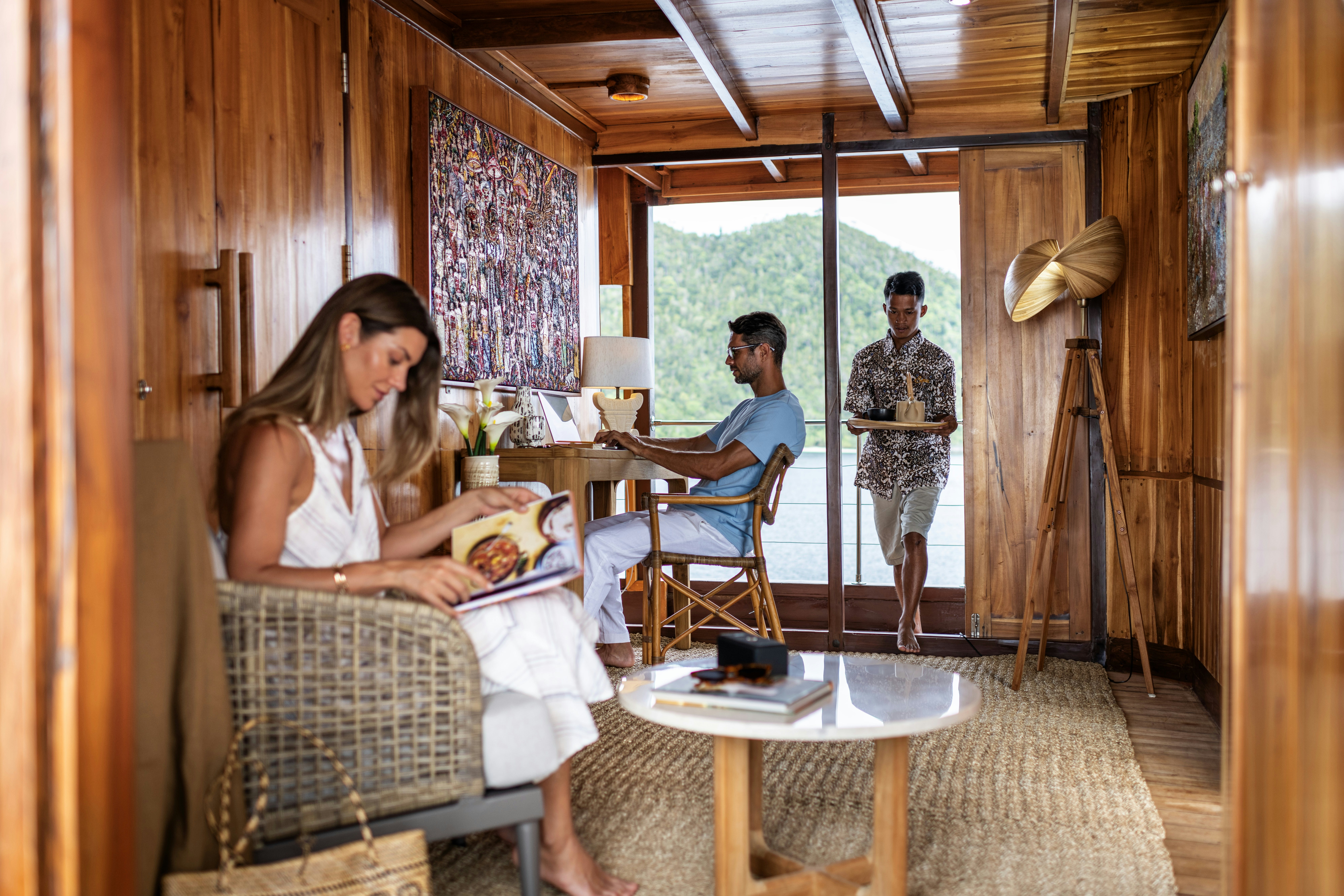 a man and woman sitting in a room aboard SEQUOIA Yacht for Charter