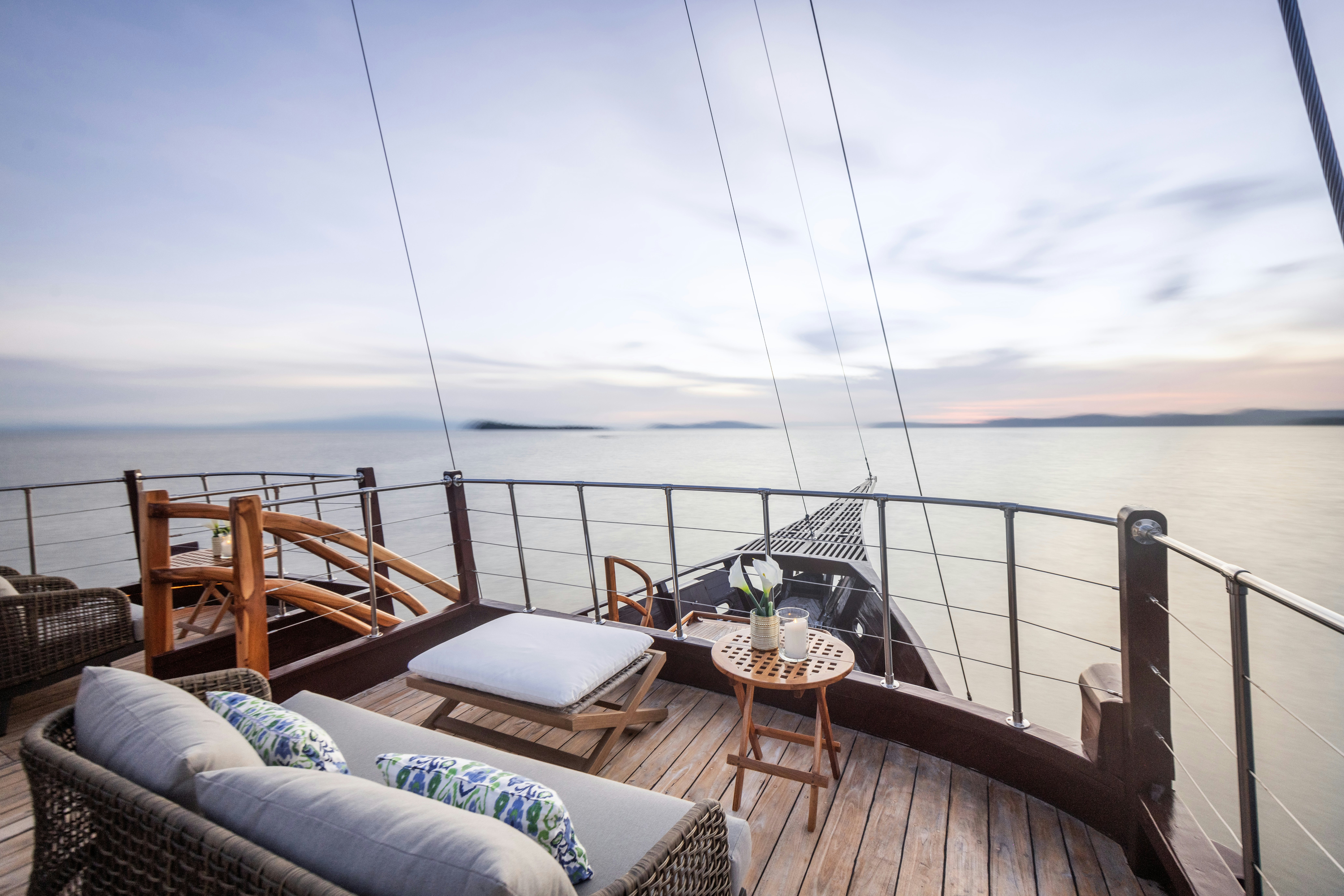 a deck with a table and chairs on it aboard SEQUOIA Yacht for Charter