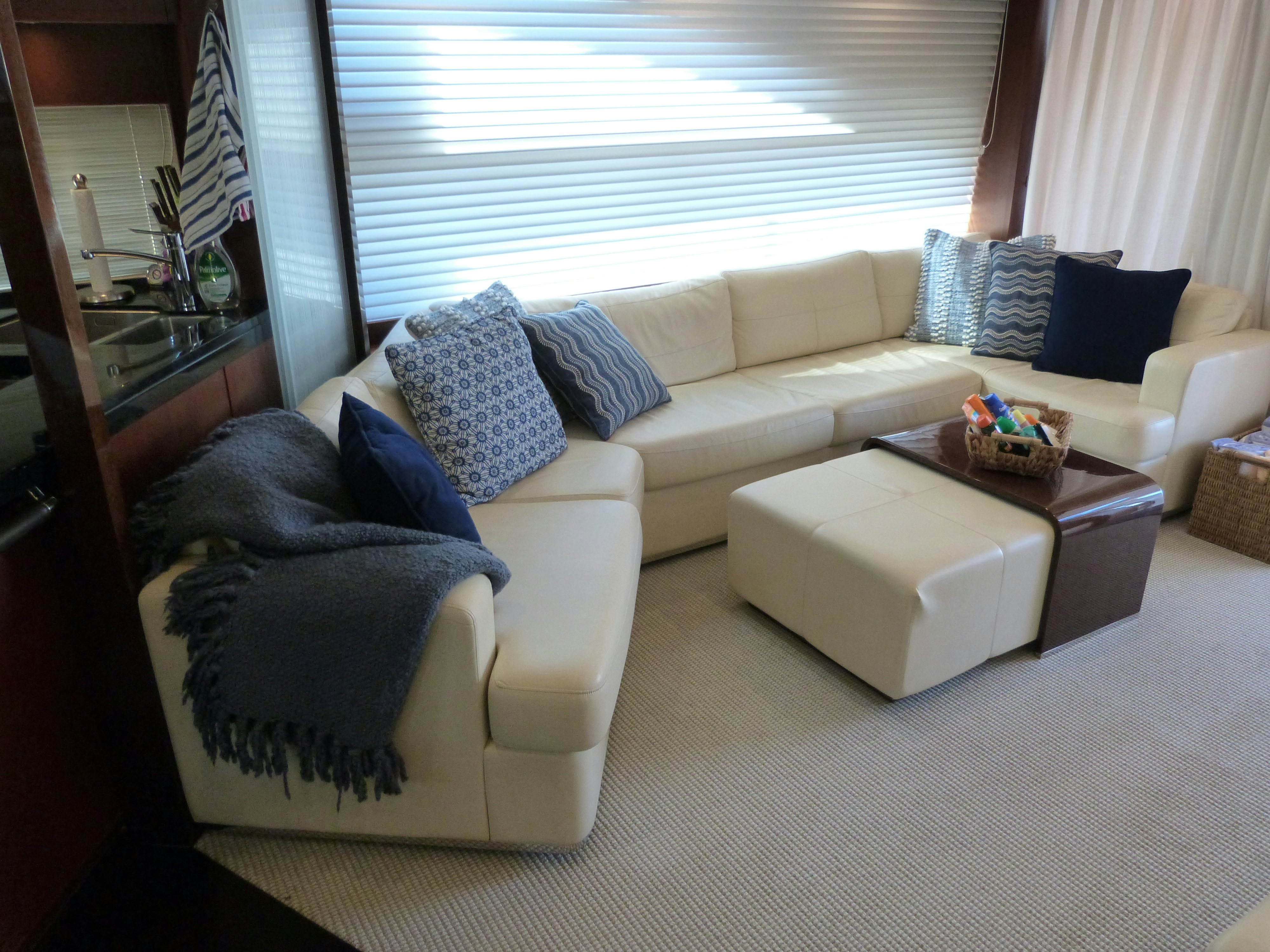 a living room with a couch and a window aboard LADY A Yacht for Sale