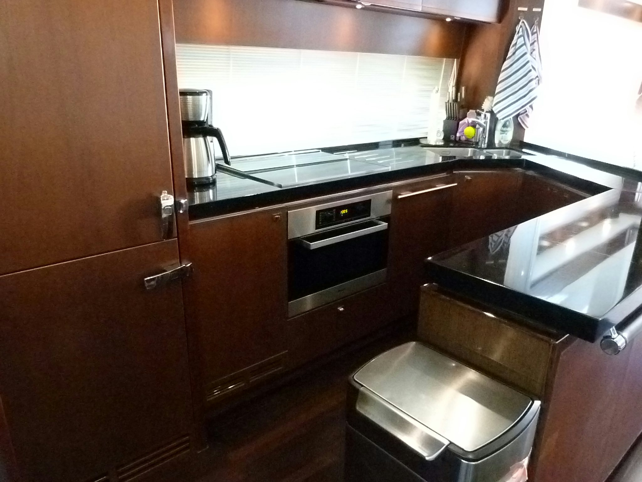 a kitchen with black counters aboard LADY A Yacht for Sale
