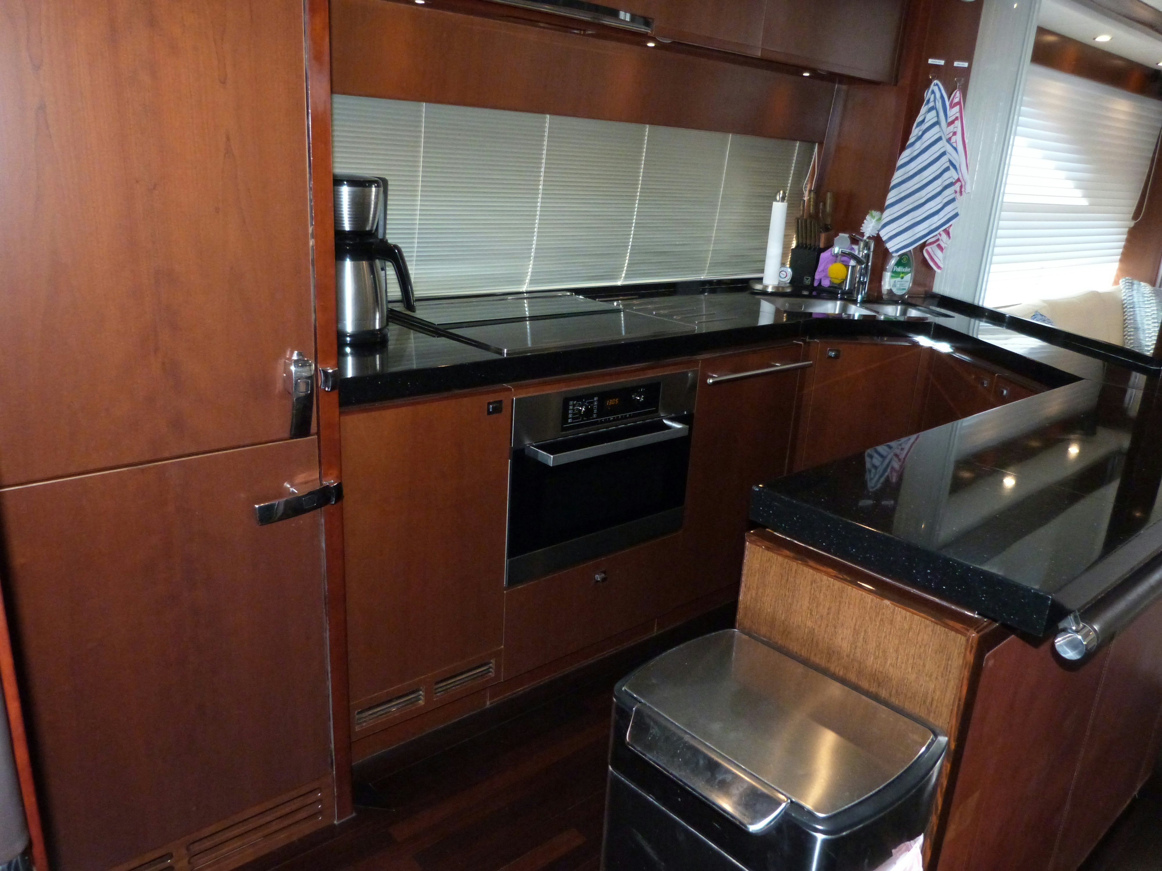 a kitchen with wooden cabinets aboard LADY A Yacht for Sale