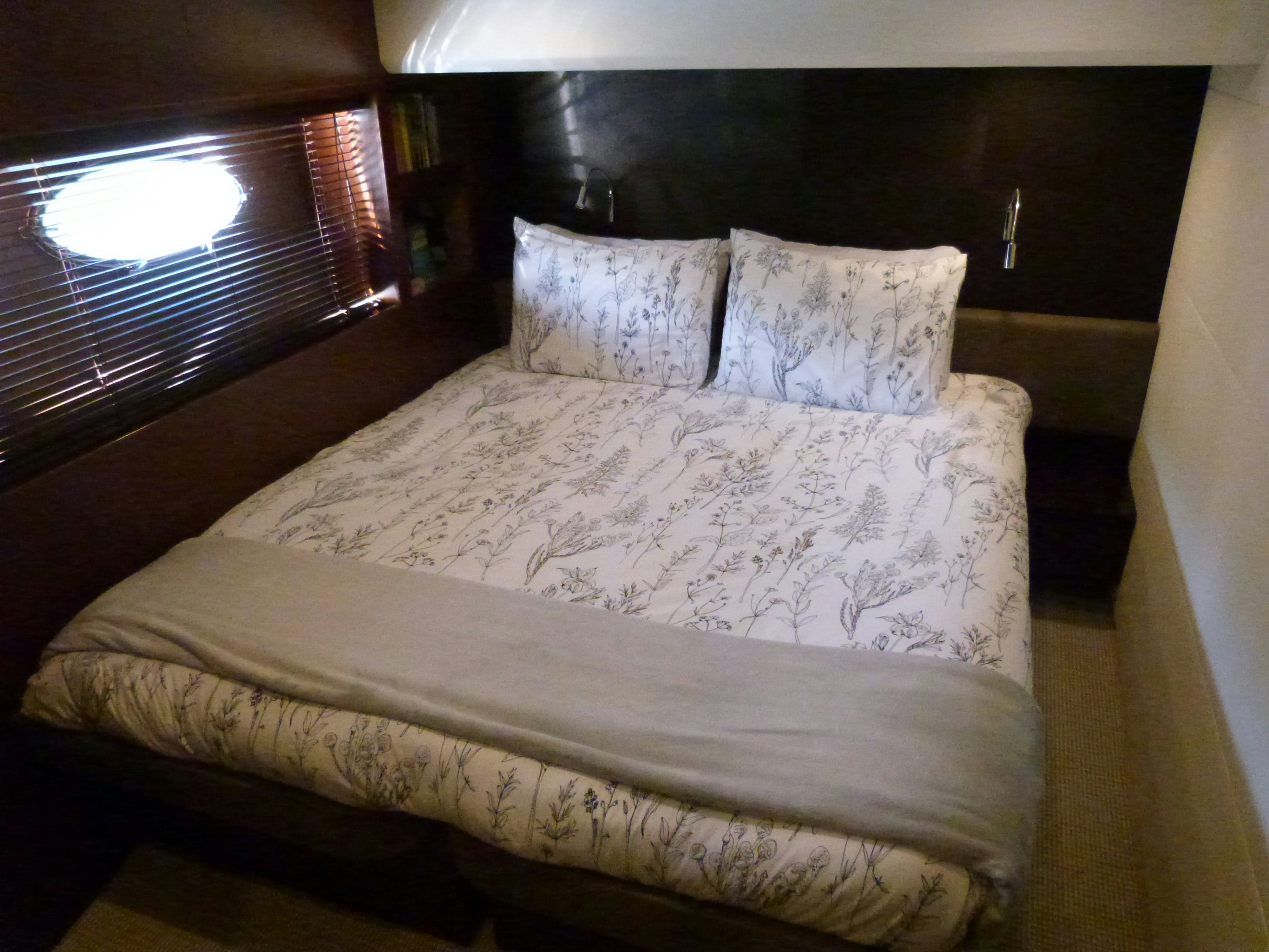 a bed with white sheets aboard LADY A Yacht for Sale