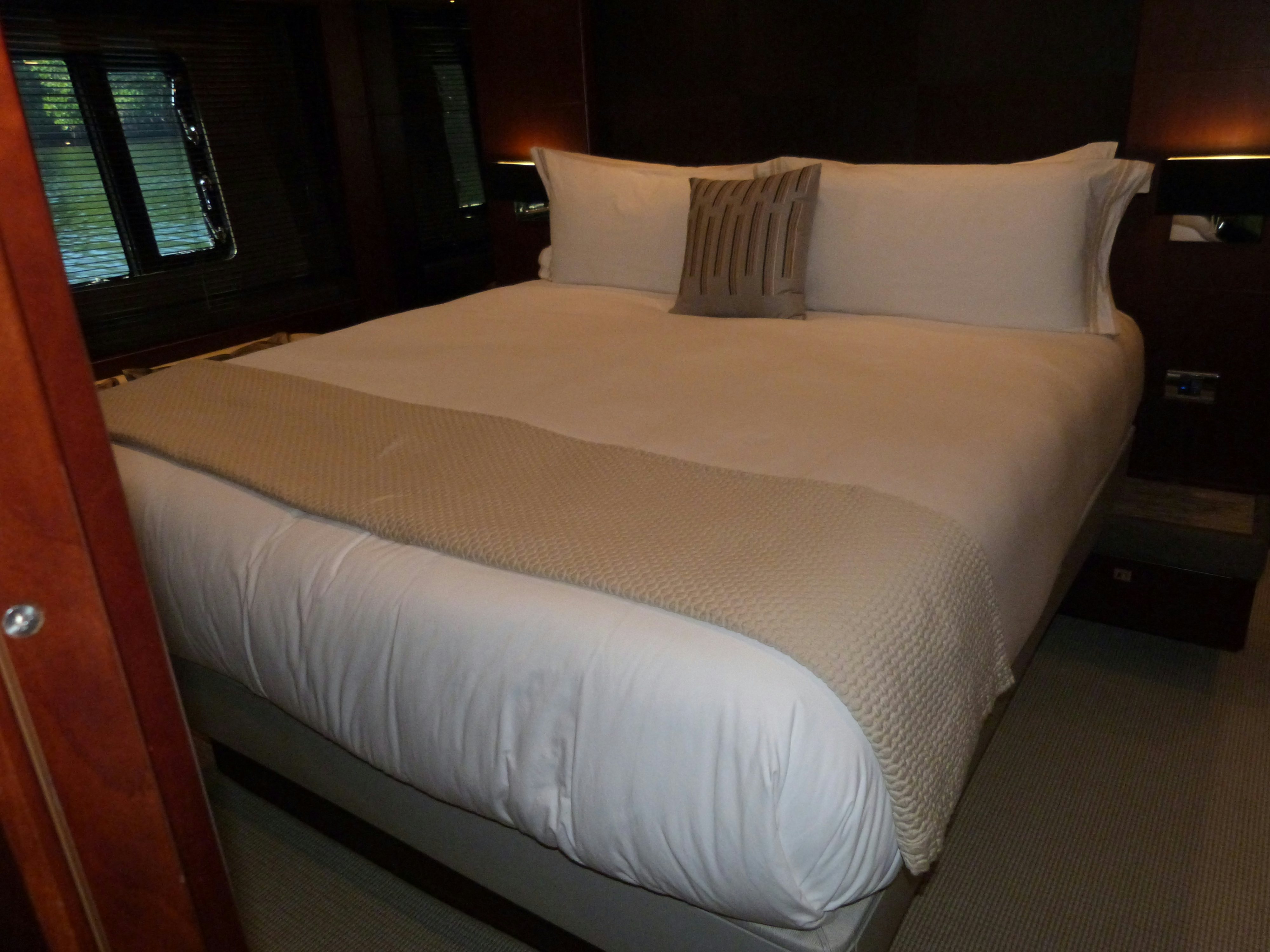 a bed with white sheets aboard LADY A Yacht for Sale