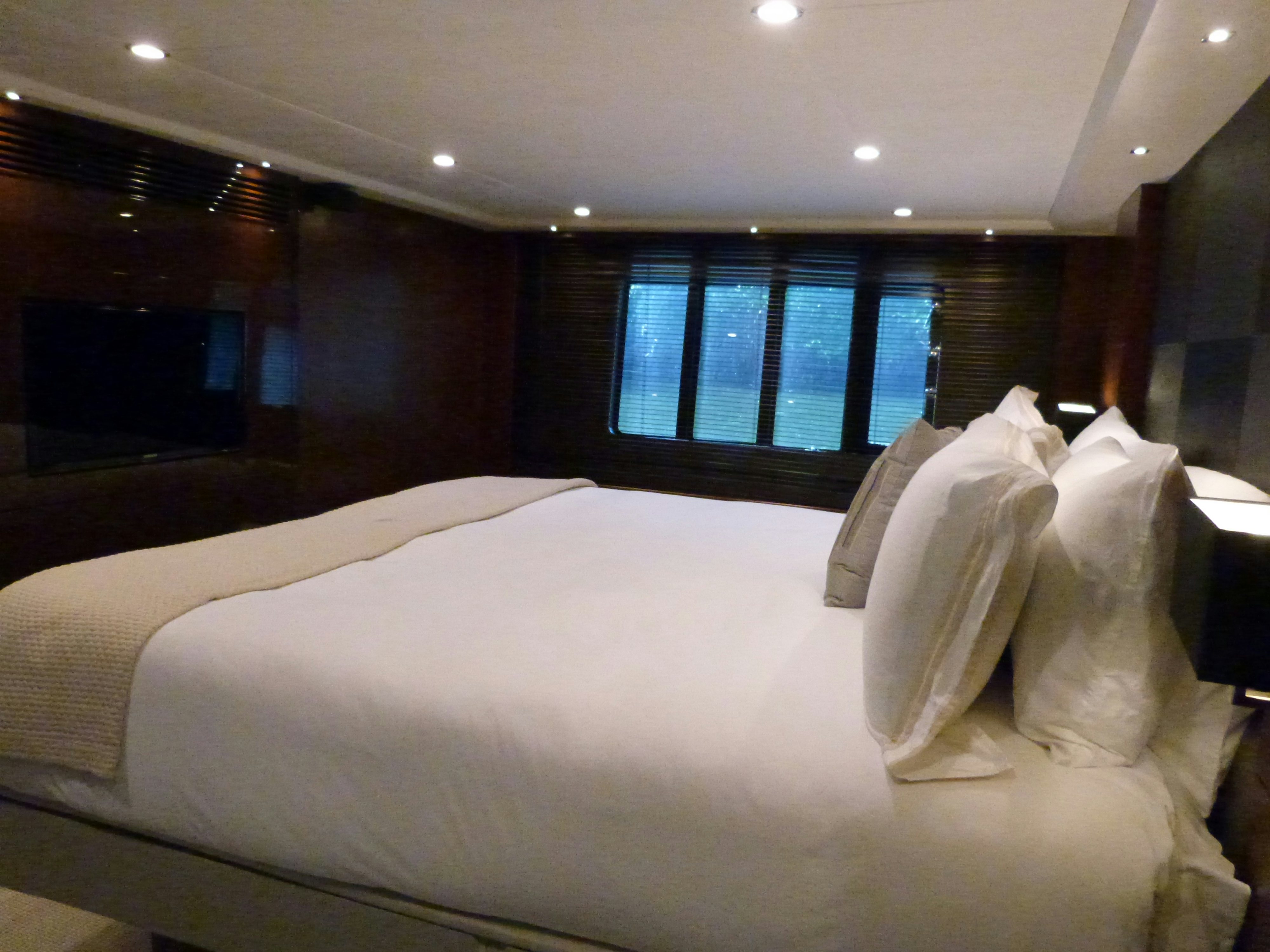 a room with a bed and a window aboard LADY A Yacht for Sale