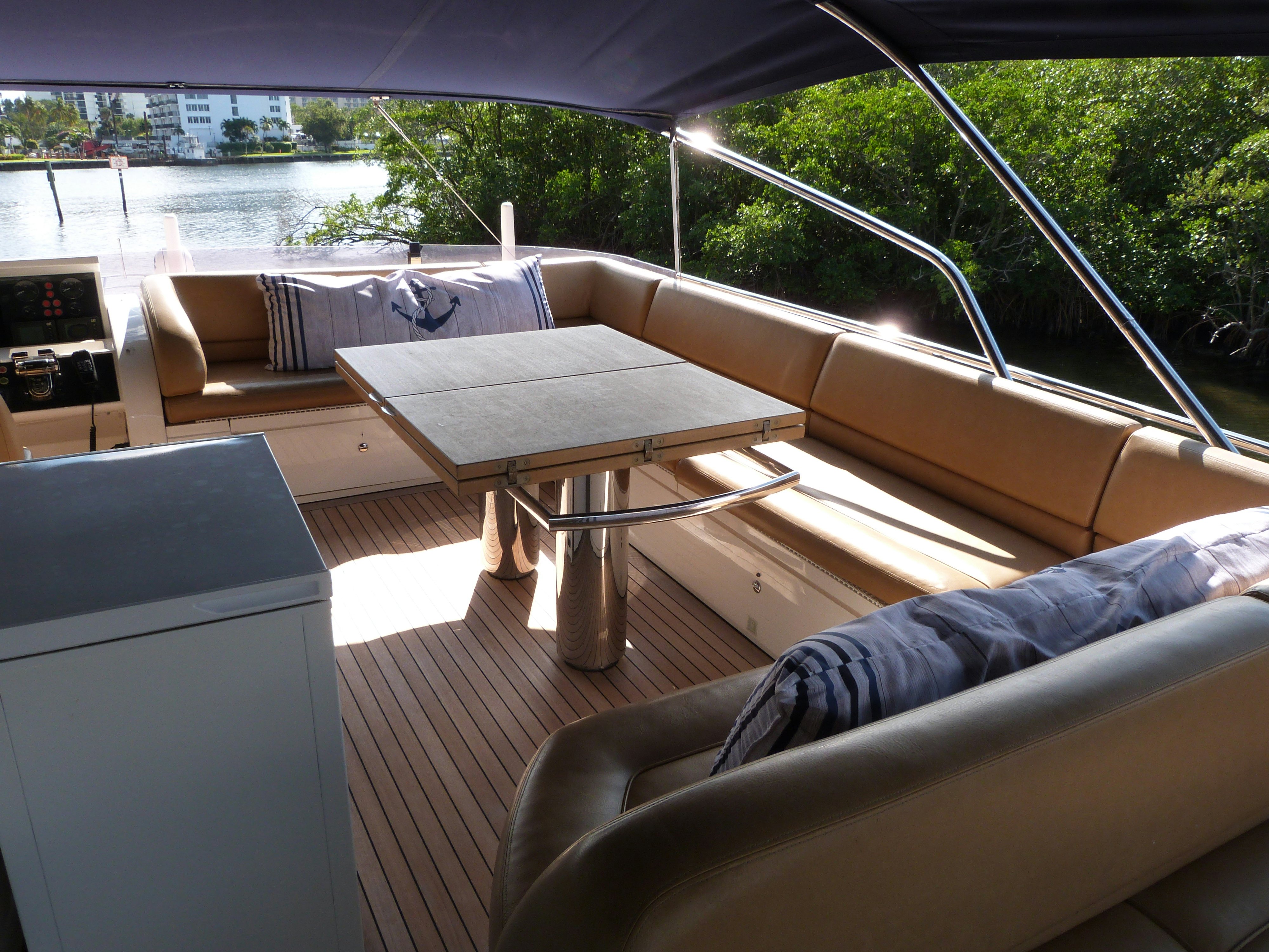 a couch and a table in a room with a view of a city aboard LADY A Yacht for Sale