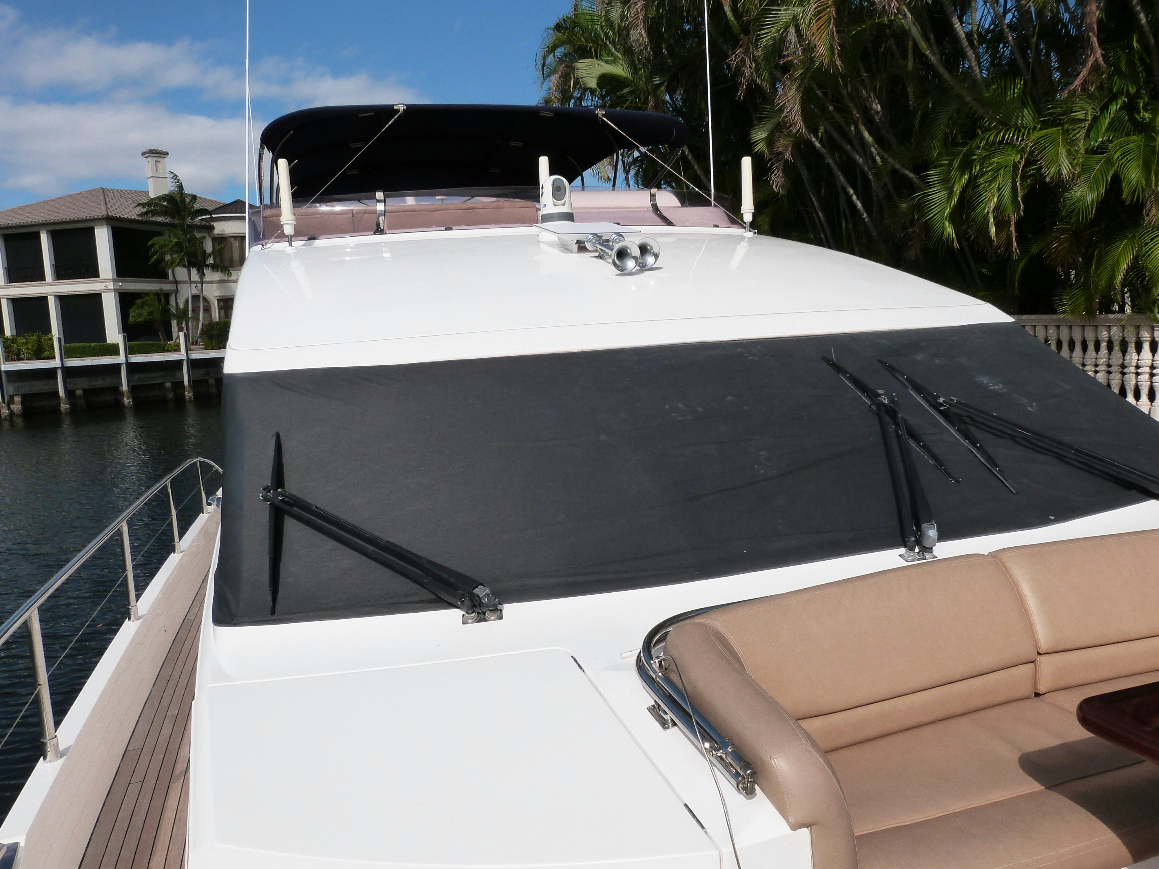 a white boat with a black canopy aboard LADY A Yacht for Sale
