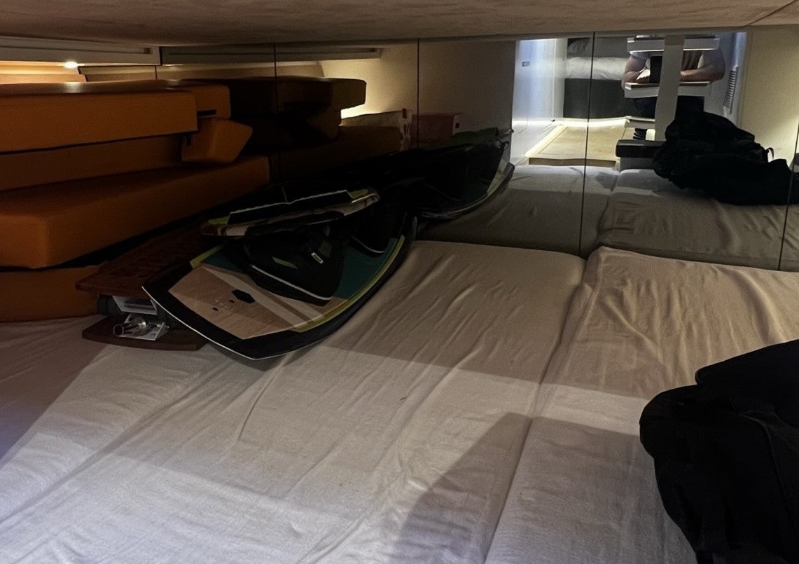 a bed with a black and white bed spread aboard MONEYPENNY Yacht for Sale