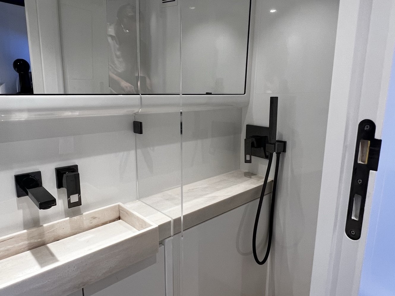 a white wall with a black handle aboard MONEYPENNY Yacht for Sale