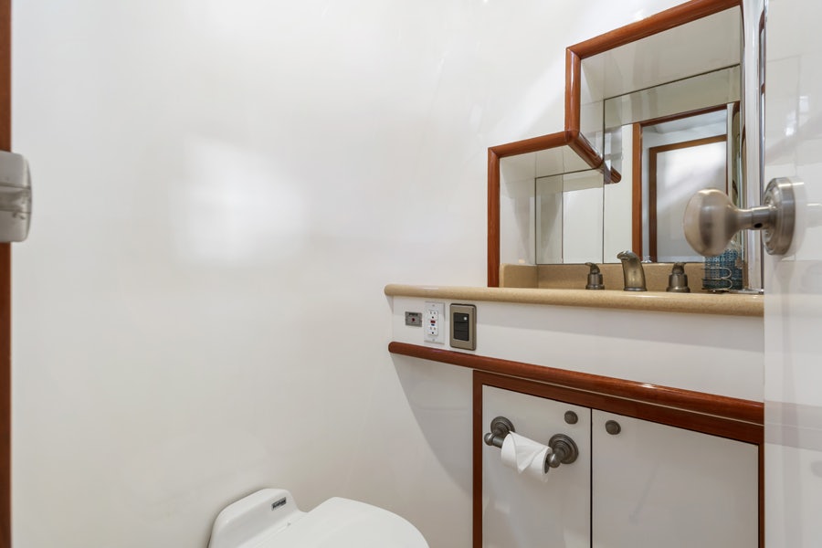 a bathroom with a mirror and a toilet aboard PORK CHOP Yacht for Sale