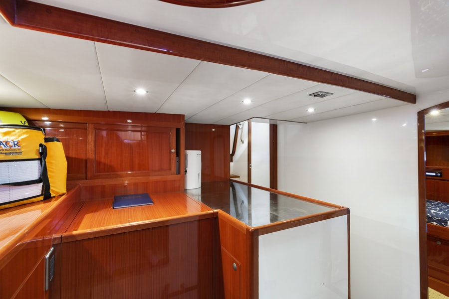 a room with wooden cabinets and a large mirror aboard PORK CHOP Yacht for Sale