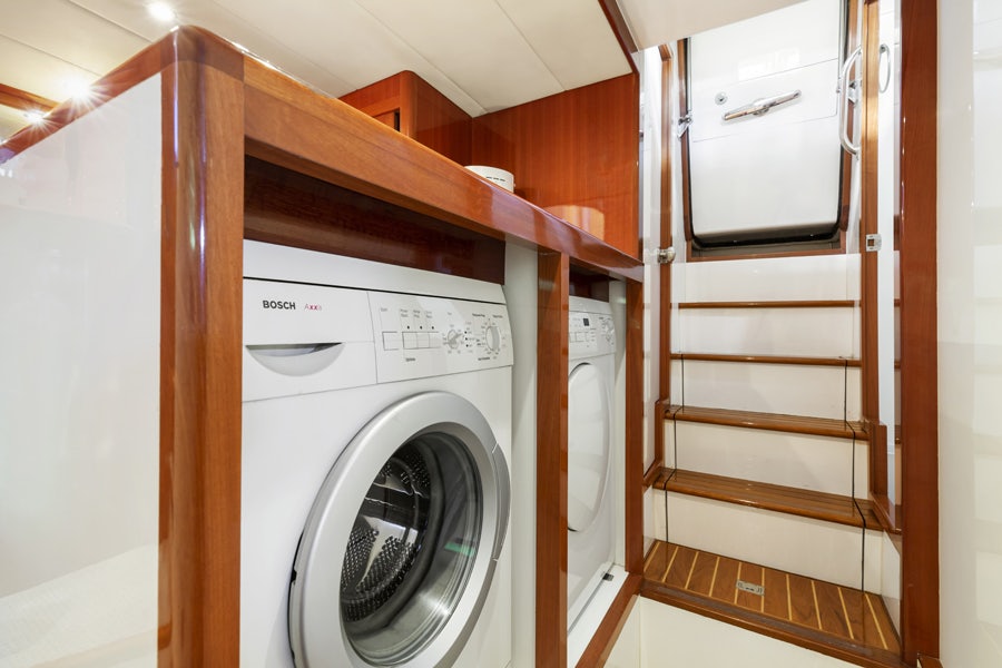 a closet with clothes dryer aboard PORK CHOP Yacht for Sale