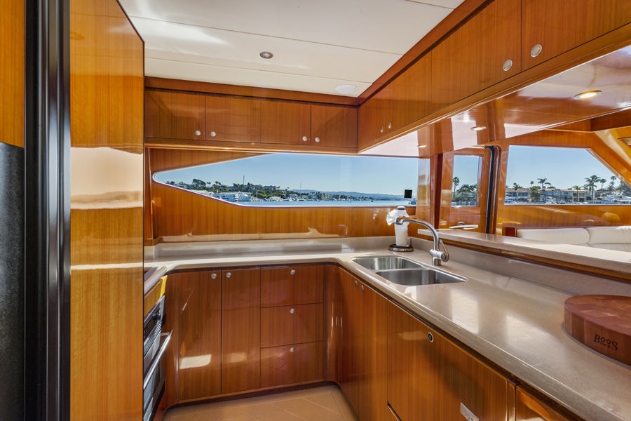 a kitchen with wooden cabinets aboard PORK CHOP Yacht for Sale