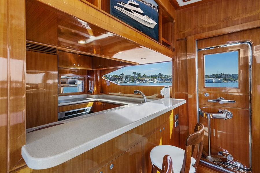 a kitchen with a large window aboard PORK CHOP Yacht for Sale